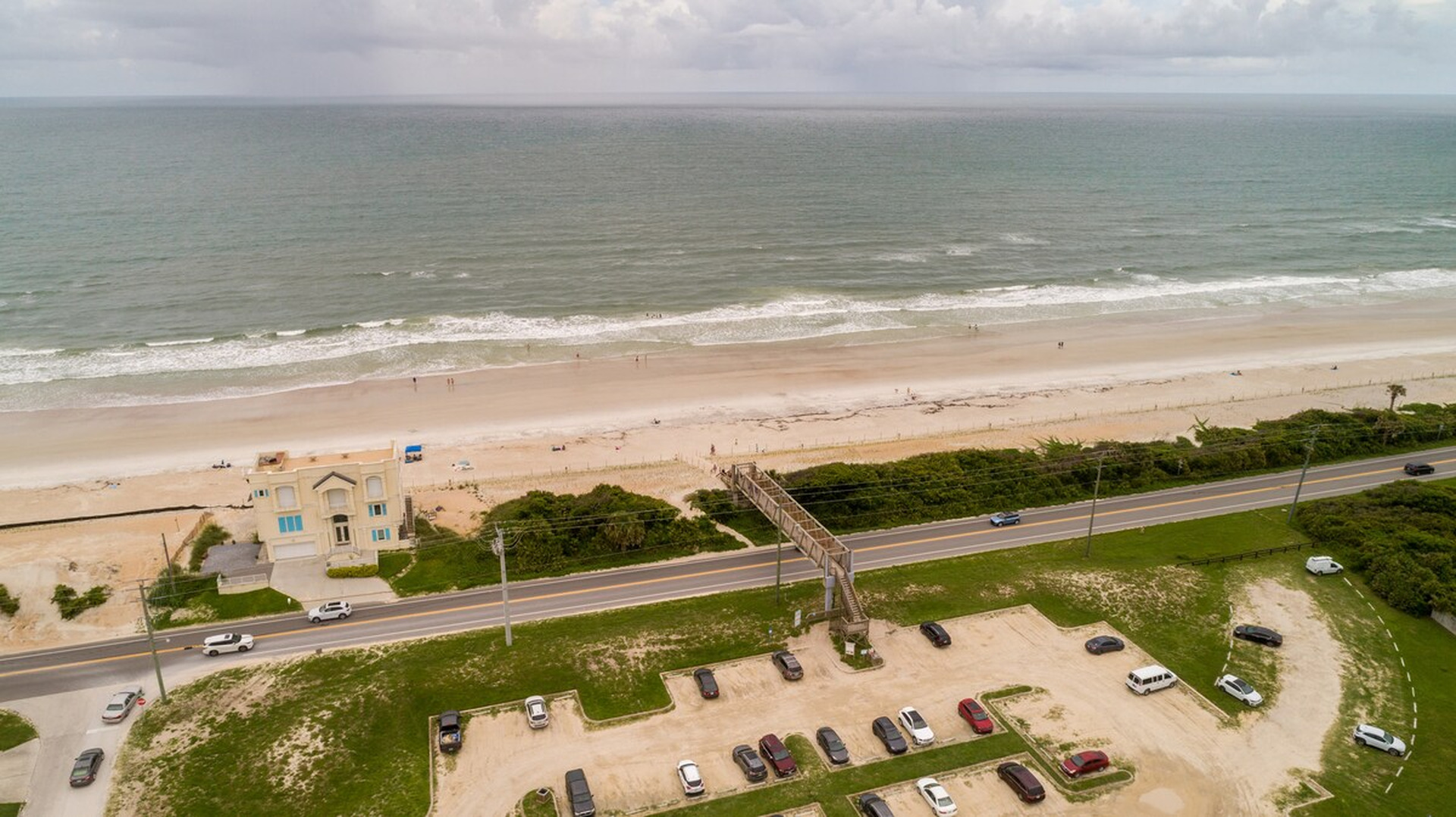 This is your beach access - a wooden walkover that lifts you across the coast road and sets you down on the sand. There is public parking at the base of it, though most days you will simply walk from the house.