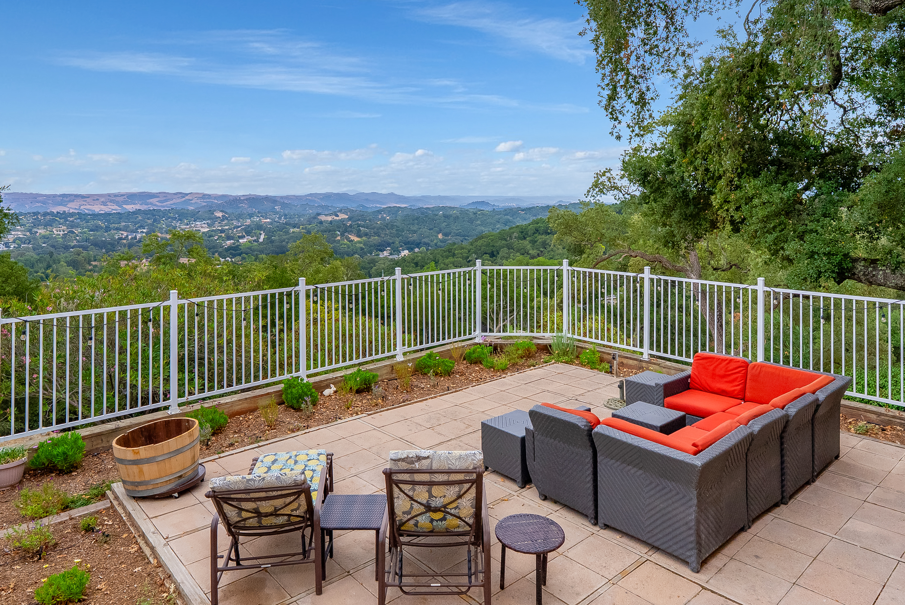 Relax on the plush sectional seating or sunny lounge chairs while taking in the spectacular, panoramic views of the rolling hills and distant landscape from this expansive, private patio.