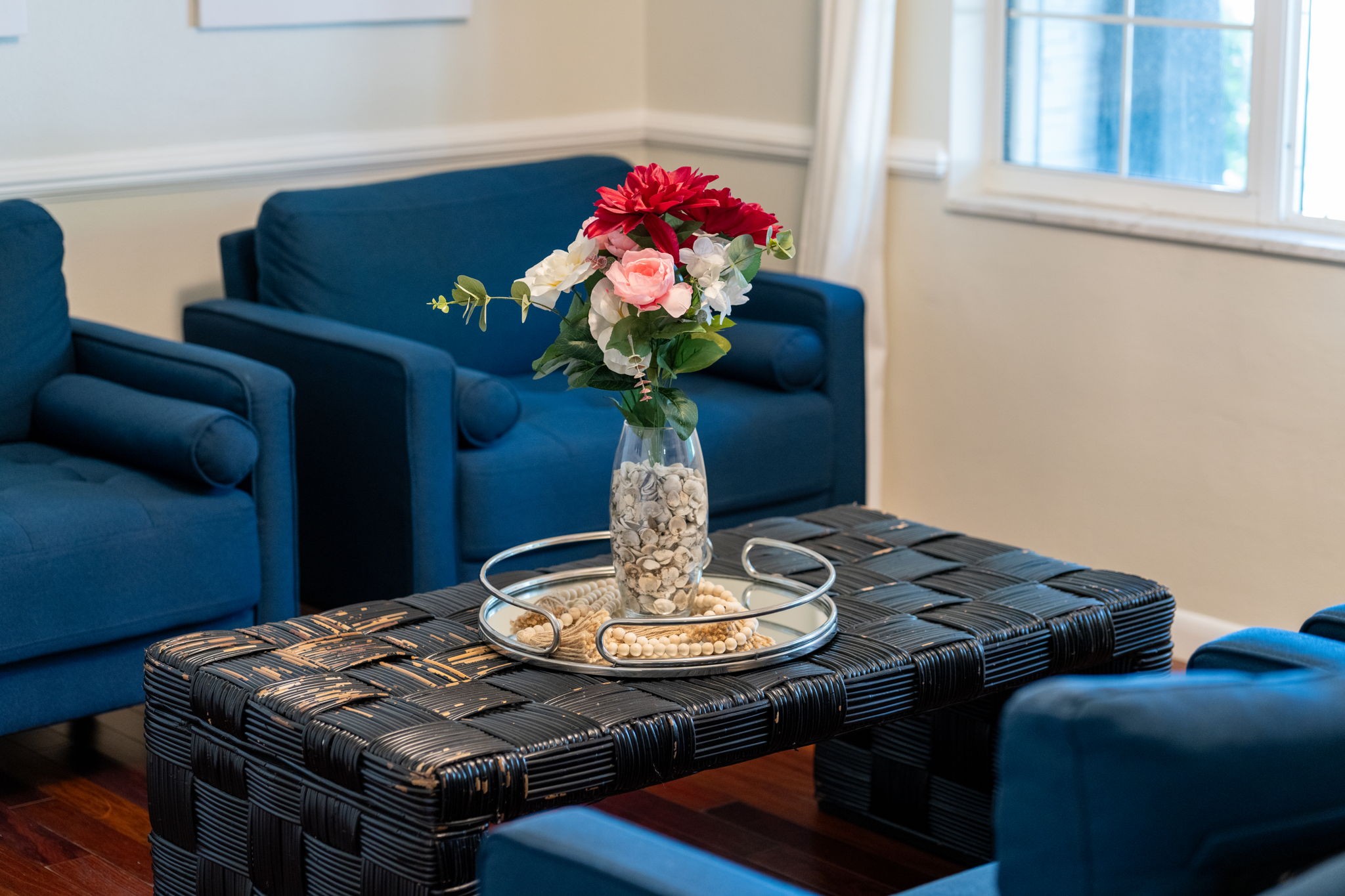 Blue upholstered chairs provide a pop of color, creating a warm and welcoming space for family and friends.