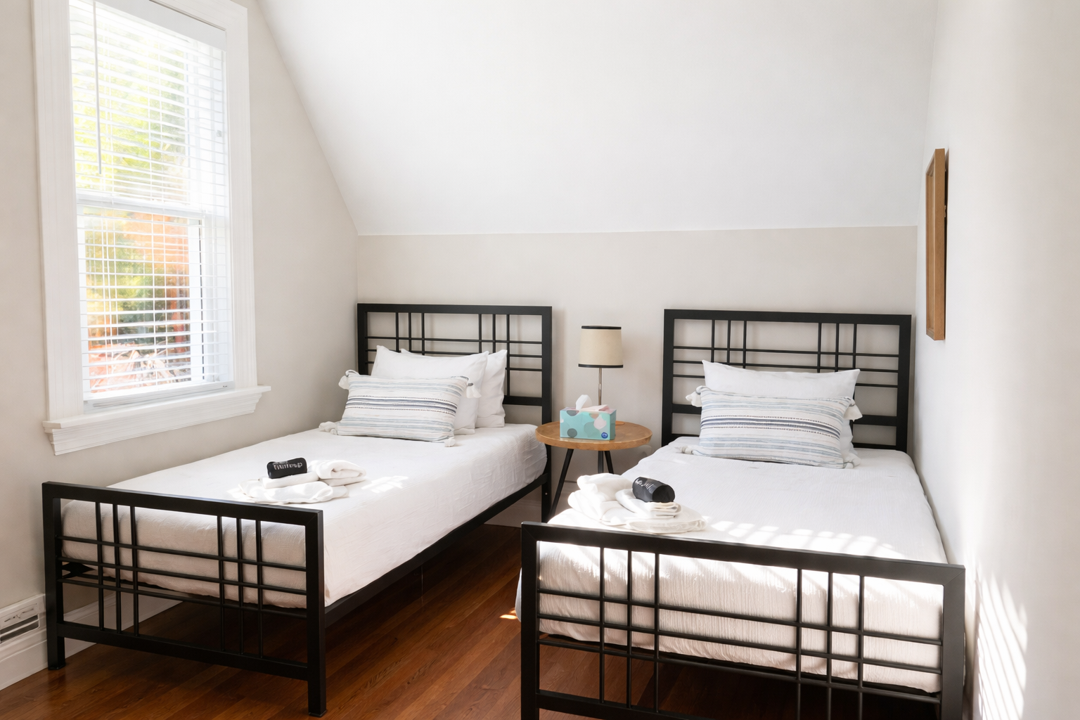 Perfect for families or friends, this cozy room features two twin beds and plenty of natural light