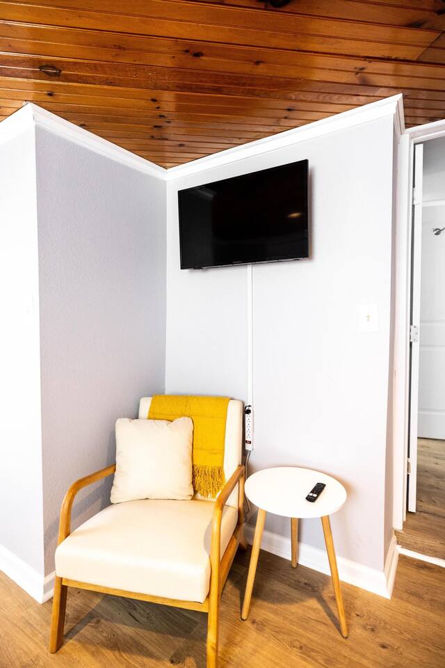 A cozy corner in the twin bedroom with a comfy chair and small table offers a peaceful spot to relax.