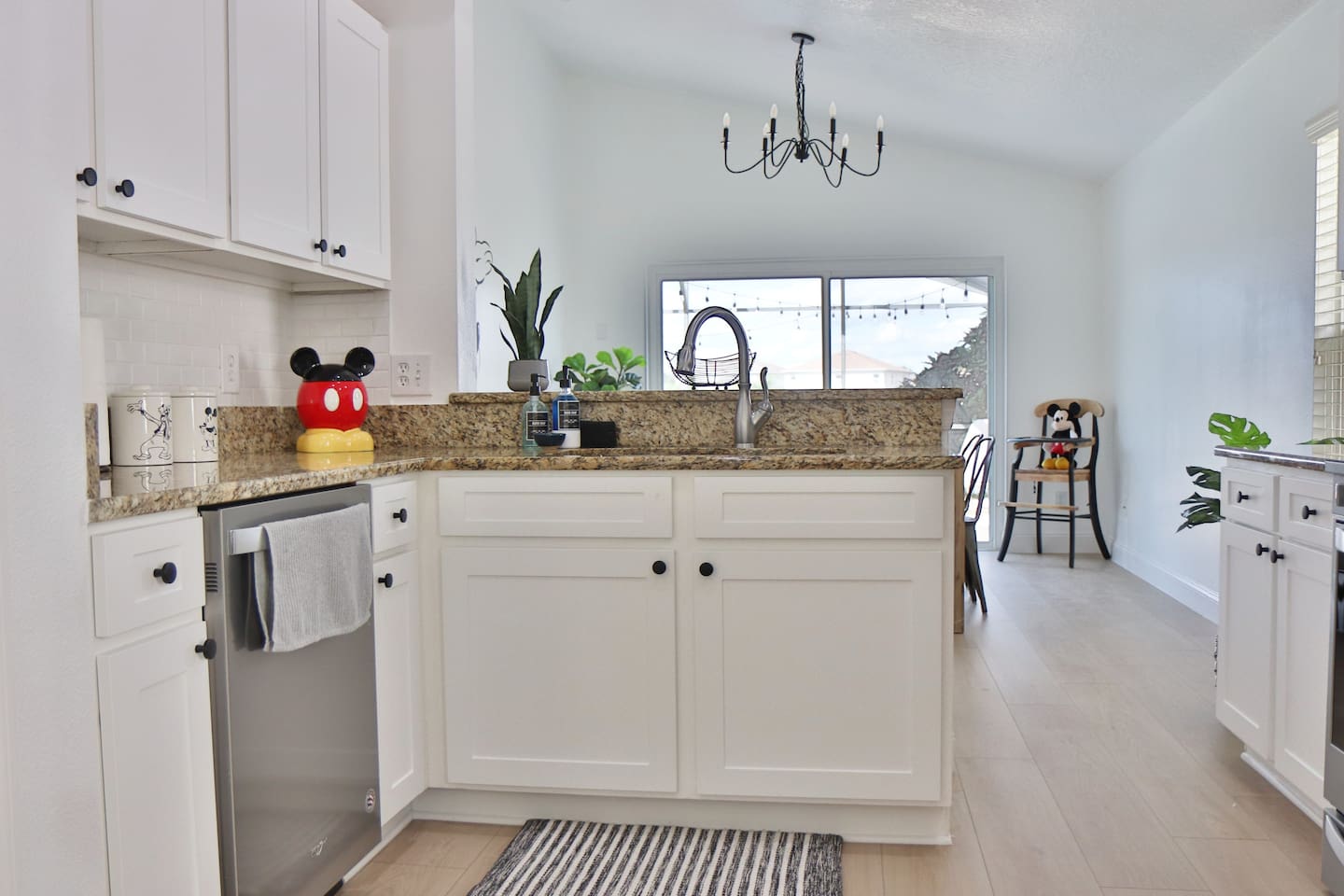 Fully stocked kitchen with dishwasher, and touches of Mickey mouse items and decor