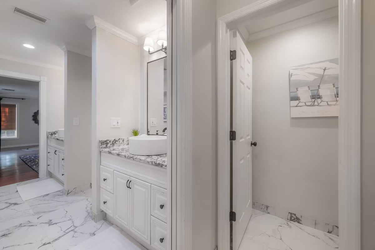 Spacious double vanity with designer mirrors and chic lighting fixtures for a refined touch.