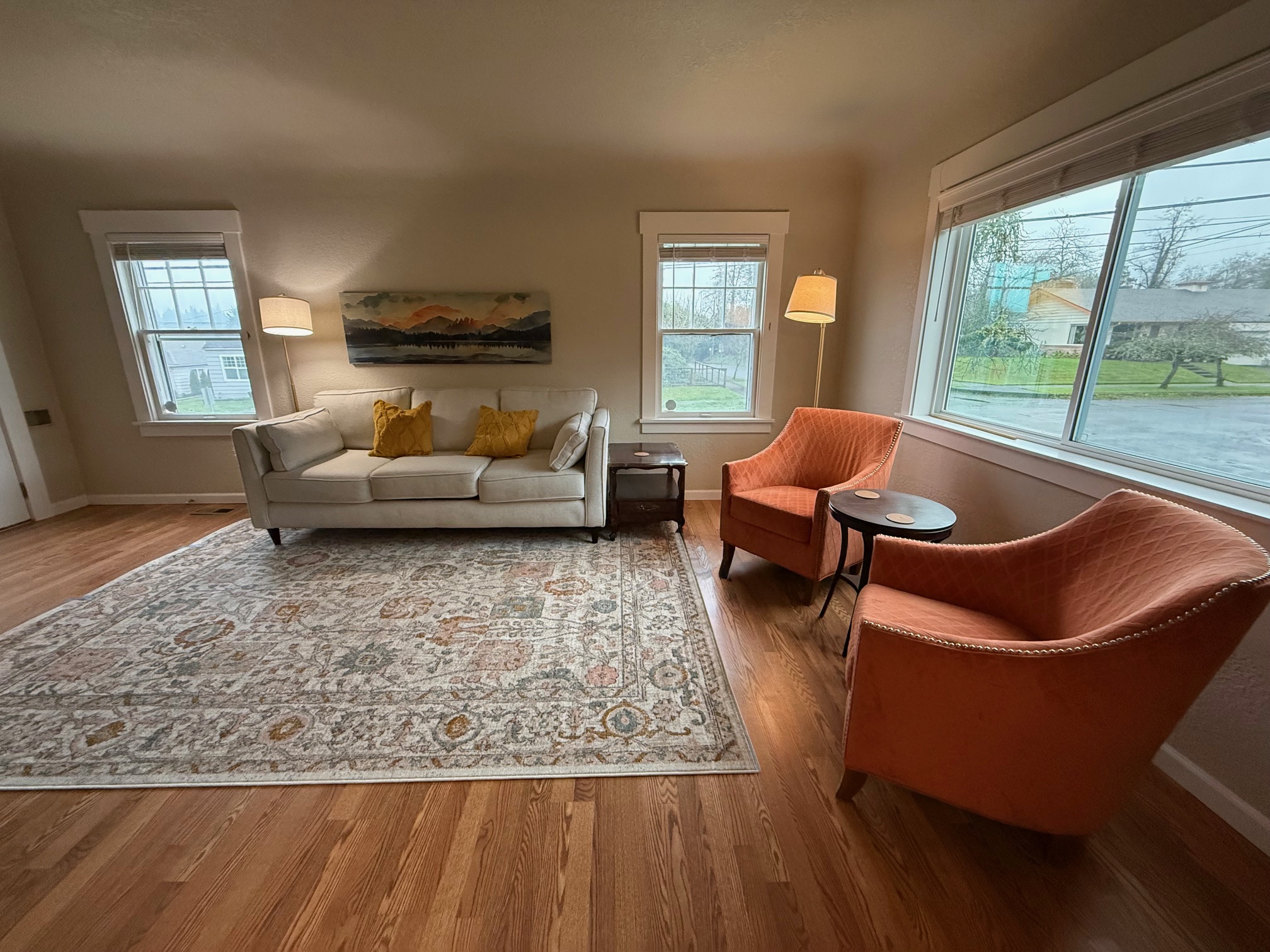 Comfortable living room sitting area with plenty of natural light and lamps