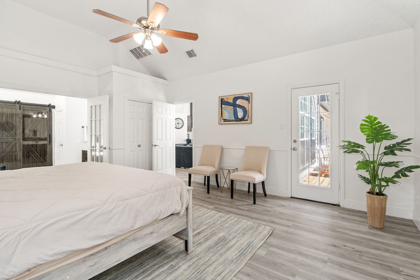 Comfortable Master bedroom with modern decor, sitting area, and plush bedding.