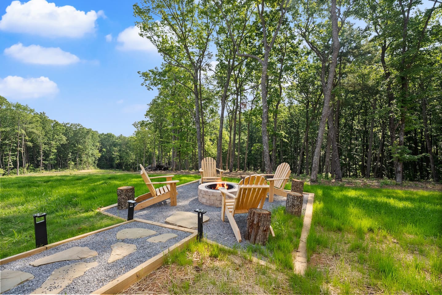 Enjoy peaceful moments or late-night laughs around the cozy fire pit, surrounded by Adirondack chairs and forest views.