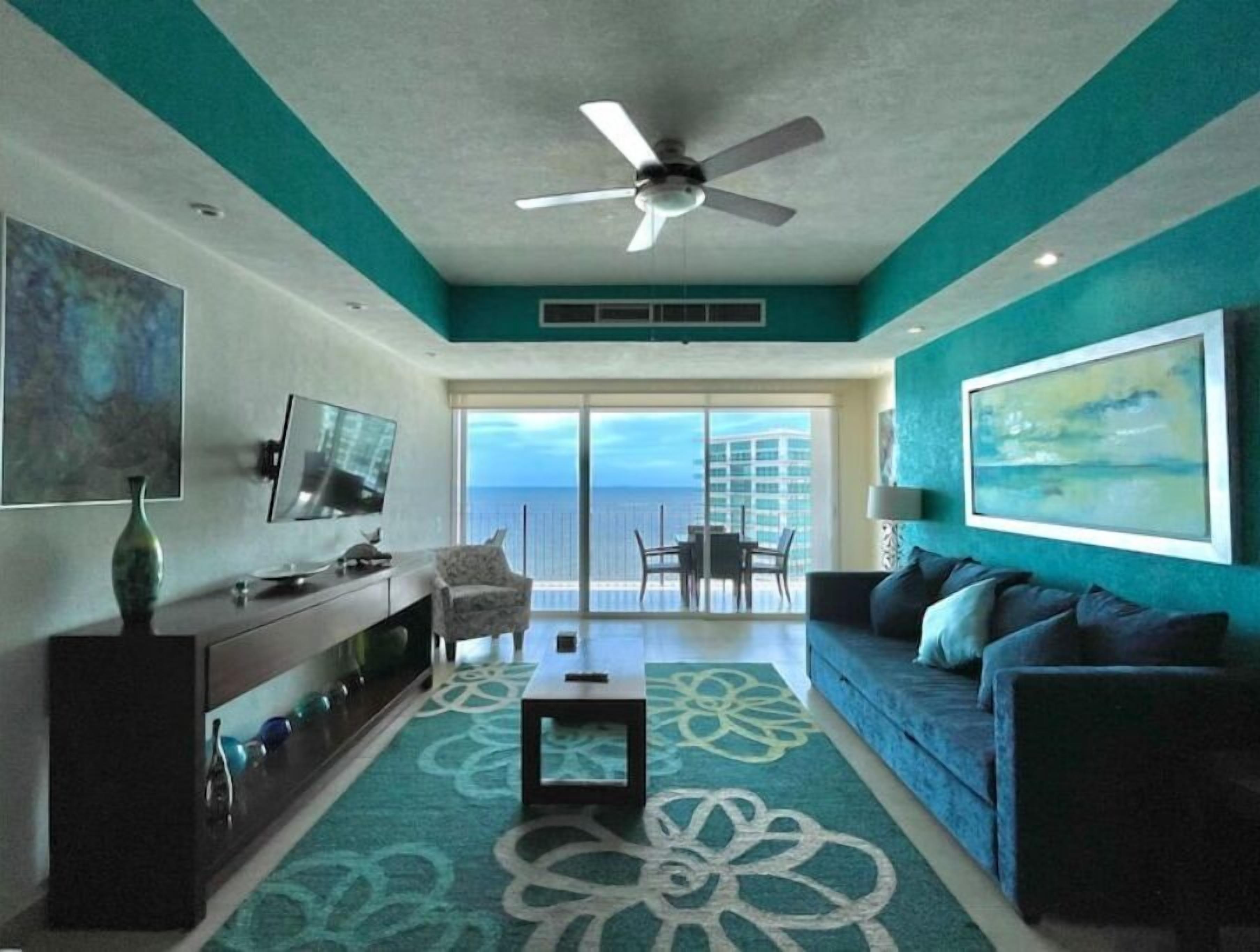 Living room opens up to the balcony overlooking the ocean. Sofa bed for 2.