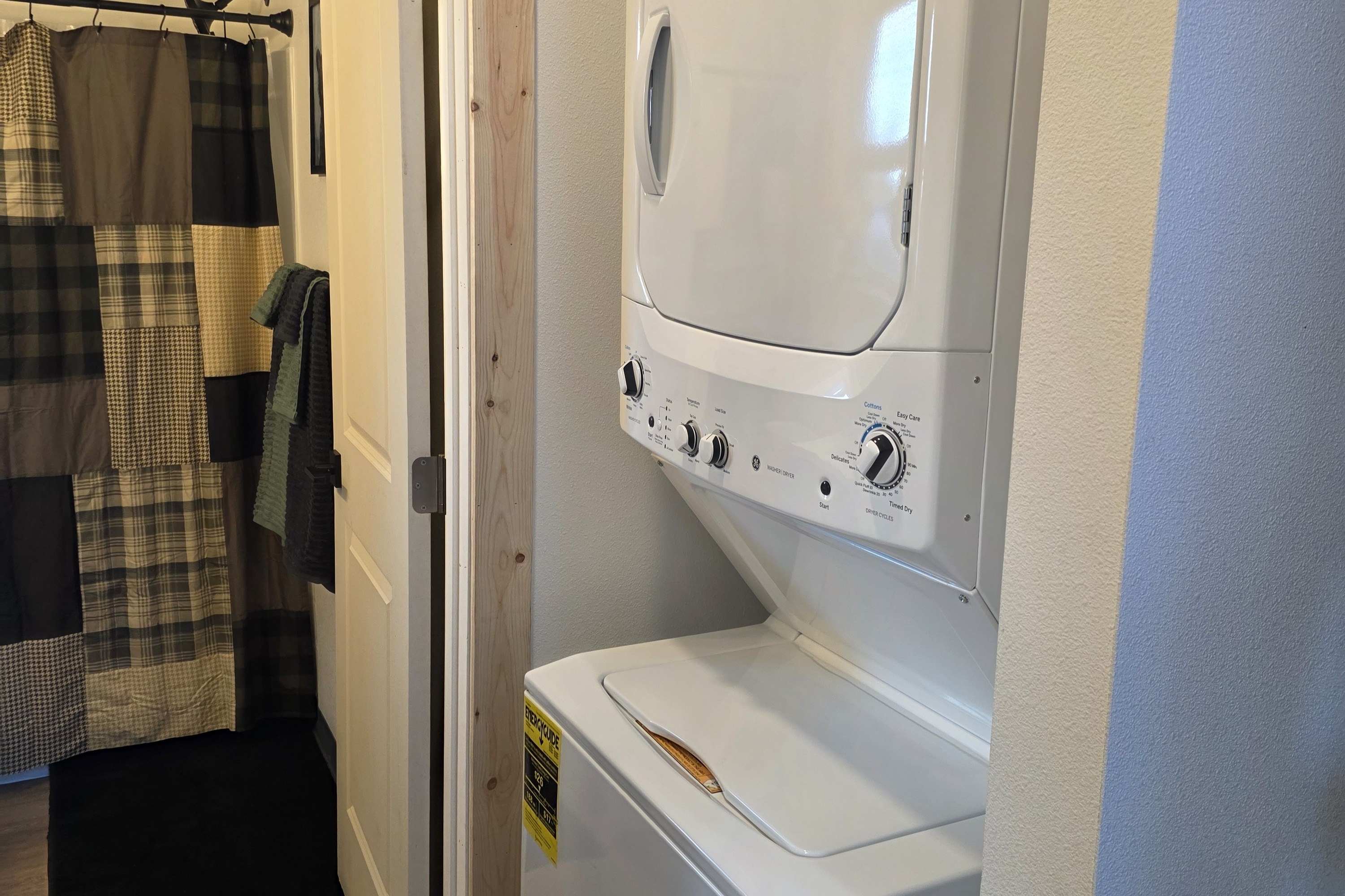Stacked Washer/Dryer located just outside of the bathroom.