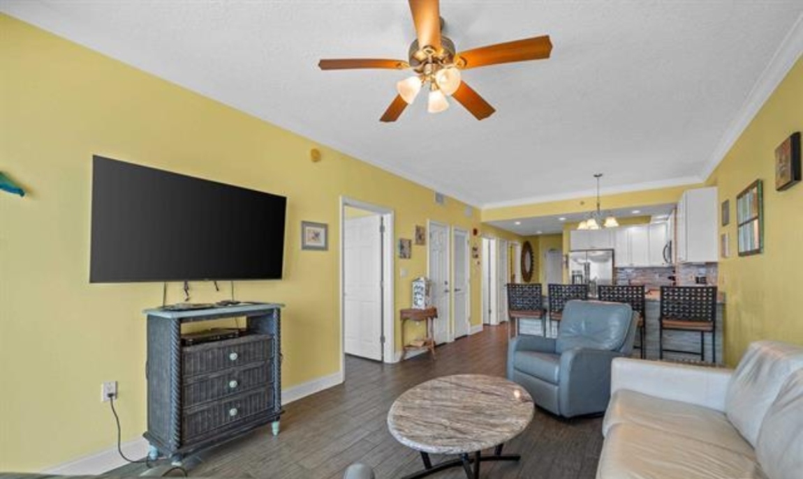 Living room with awesome view, leather queen sleeper sofa with memory foam mattress, 2 leather rocker/swivel recliners, 55" SMART TV & balcony access