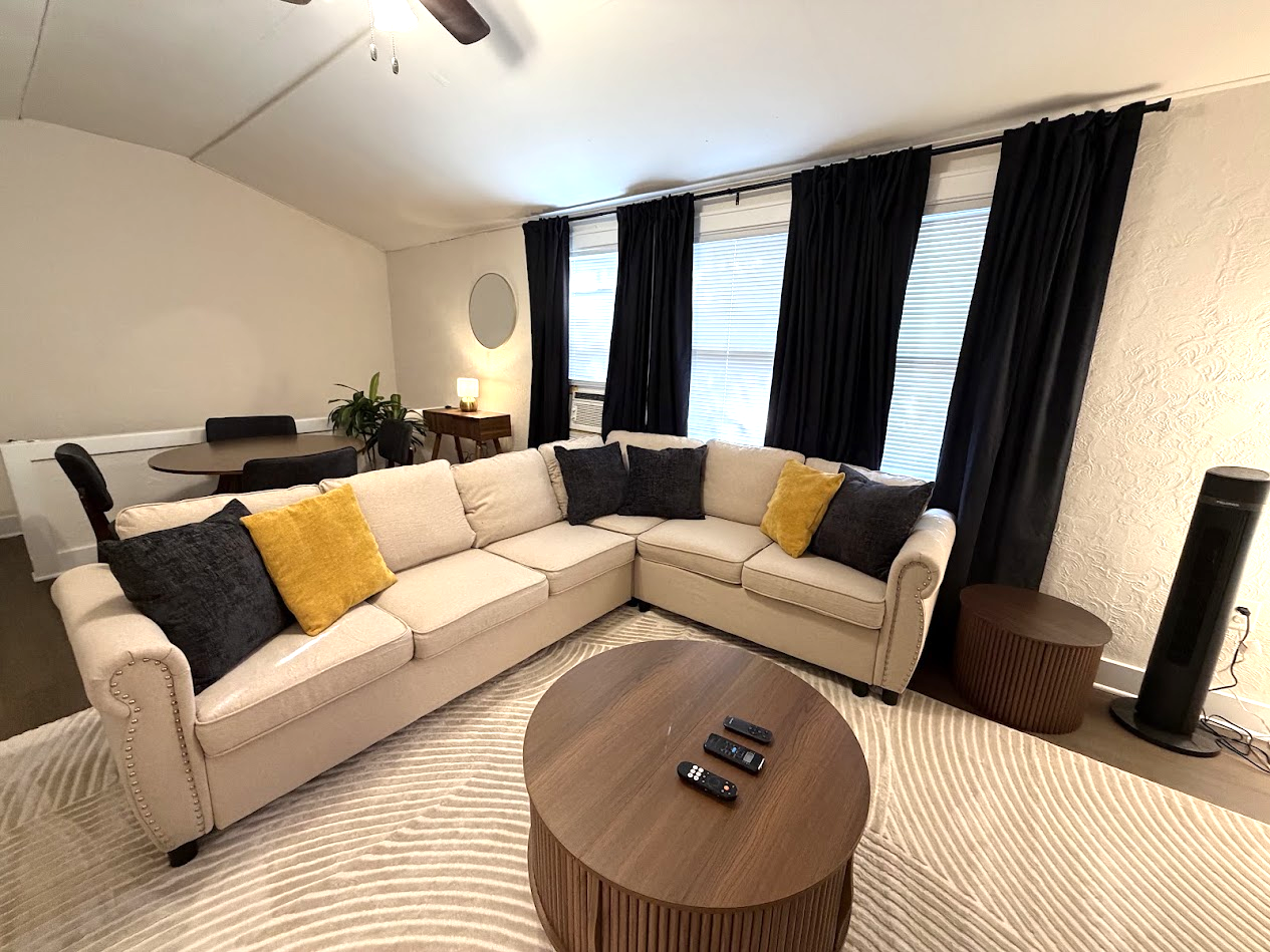 Living Area w/ 65" Smart TV and pull-out sofa bed
