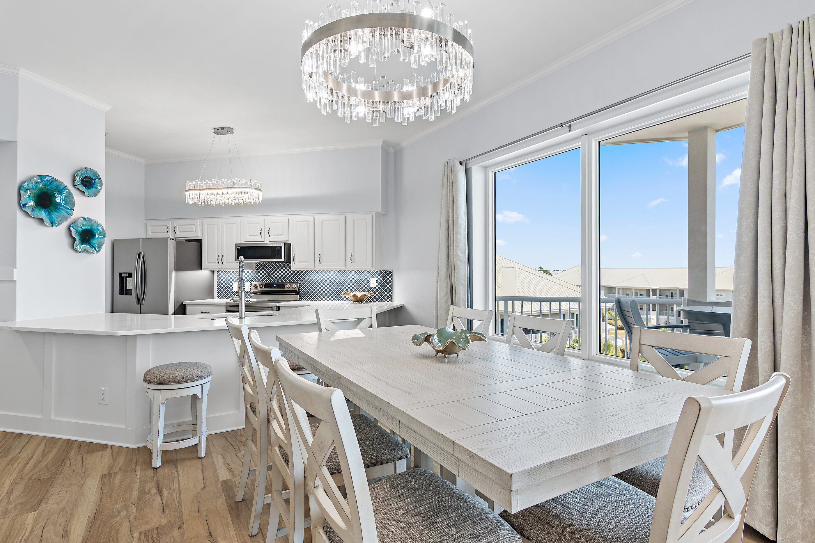 Gulf‑view dining area with elegant crystal chandelier