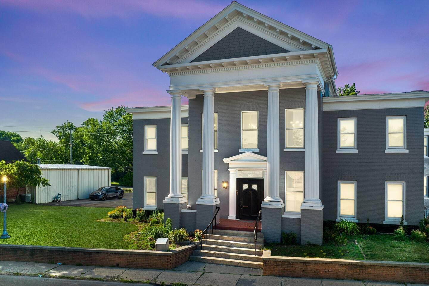Charming exterior view of the front house, showcasing its historic architecture and inviting curb appeal.