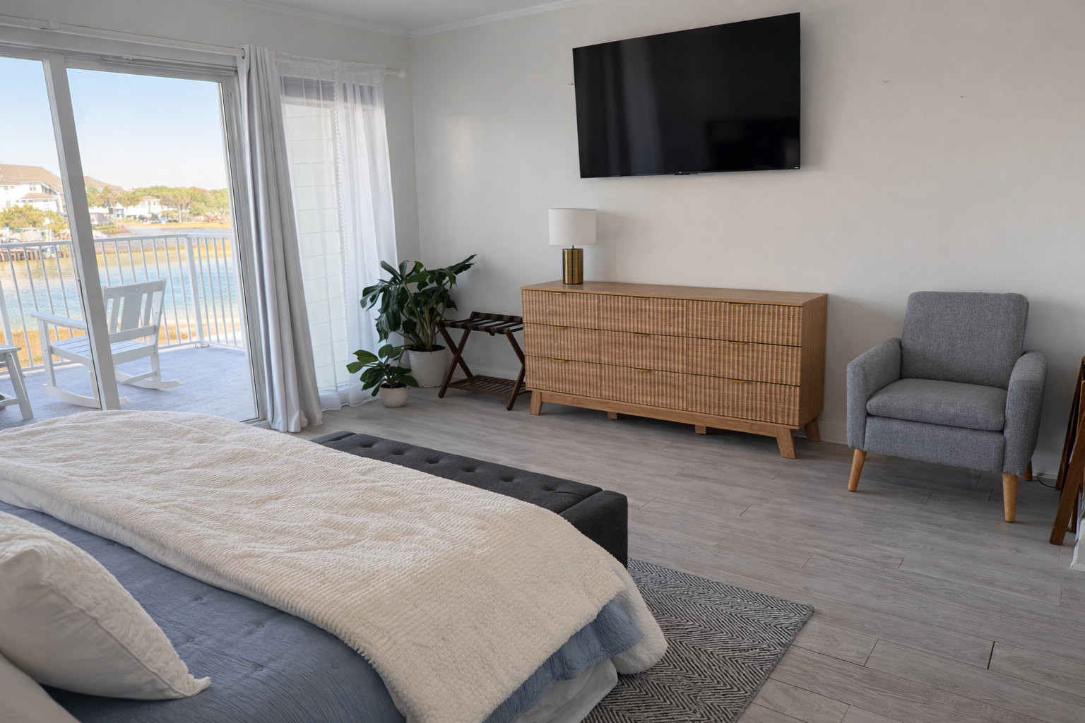 This airy bedroom offers ample space, stylish furnishings, and smart TV