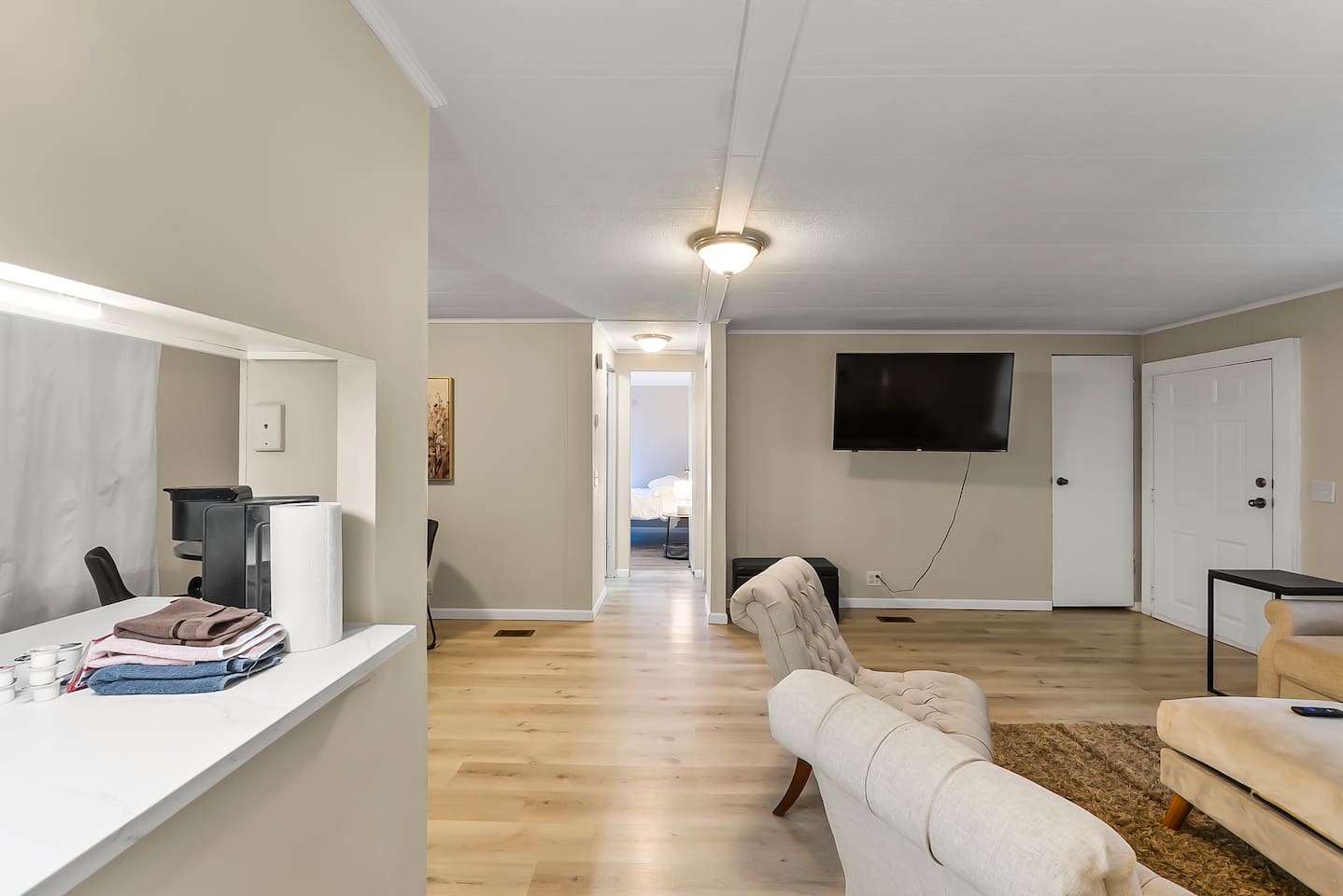 Relax and recharge in this open living space, complete with comfortable seating and modern touches.