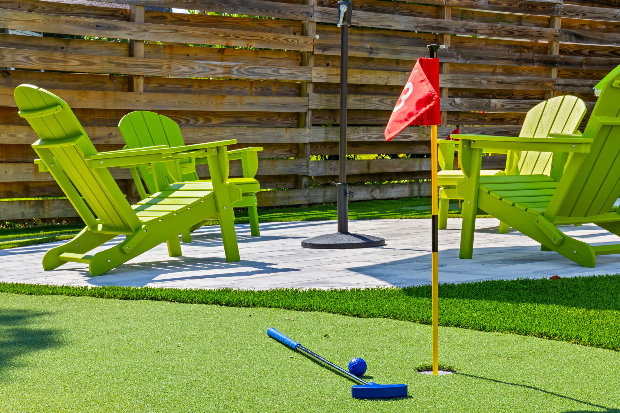 Hole 3 is a wrap! Finish your putting tournament right alongside the comfortable outdoor patio lounge. Complete with provided clubs and balls, our backyard setup makes it easy to jump from playing to relaxing.