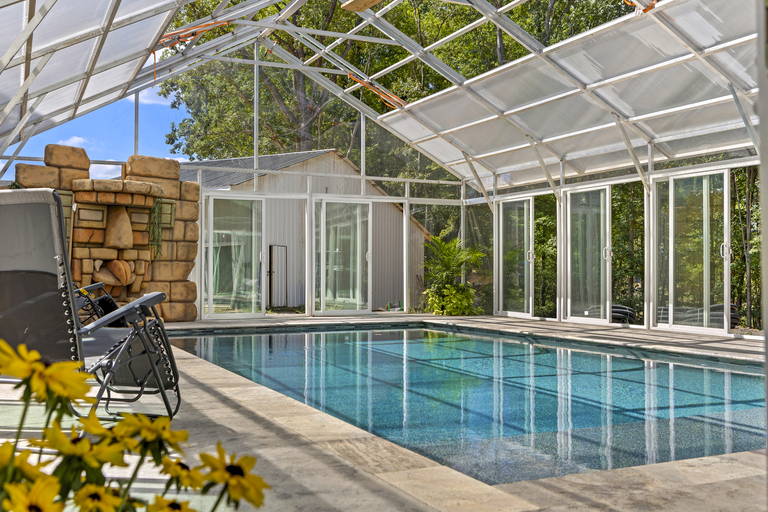 Indoor Pool Oasis: Dive into relaxation surrounded by nature and sunlight, perfect for fun!