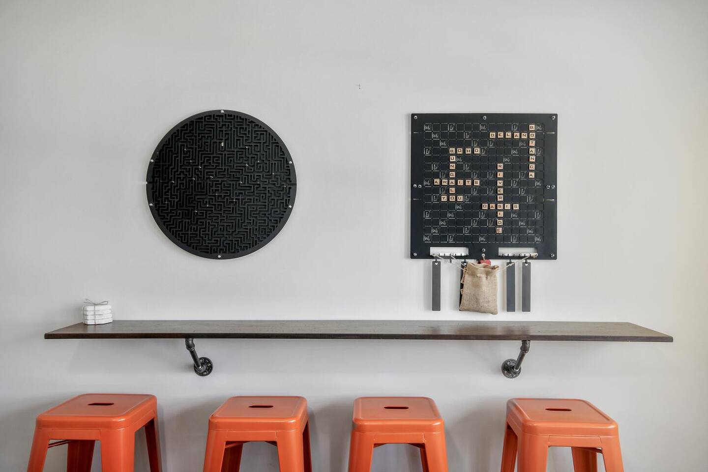 These games play on the wall itself!  Scrabble and a maze challenge game.