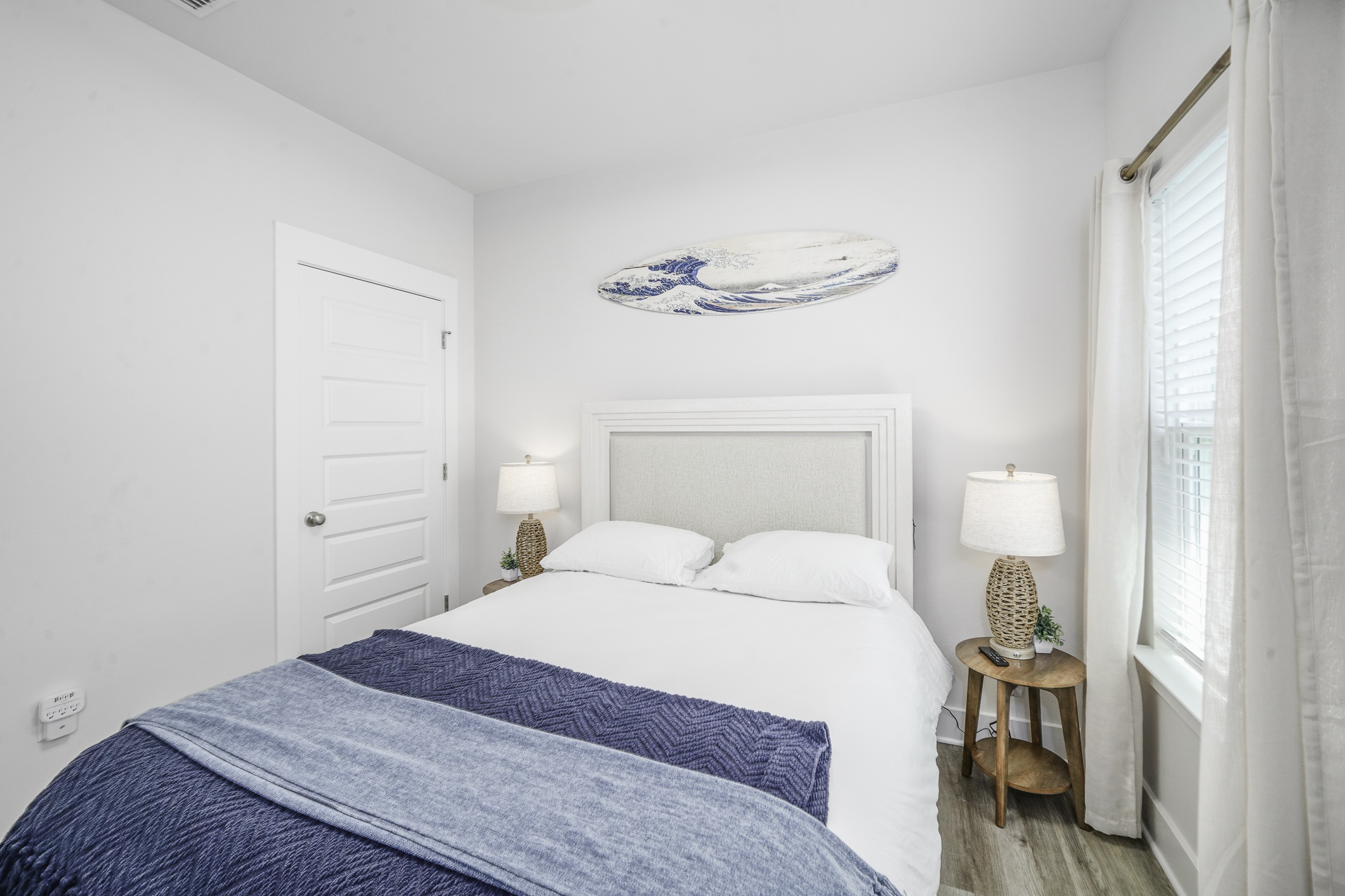 Bedroom 3: Queen bedroom, plush linens, ceiling fan, bedside lamps, wall art, and Smart TV.