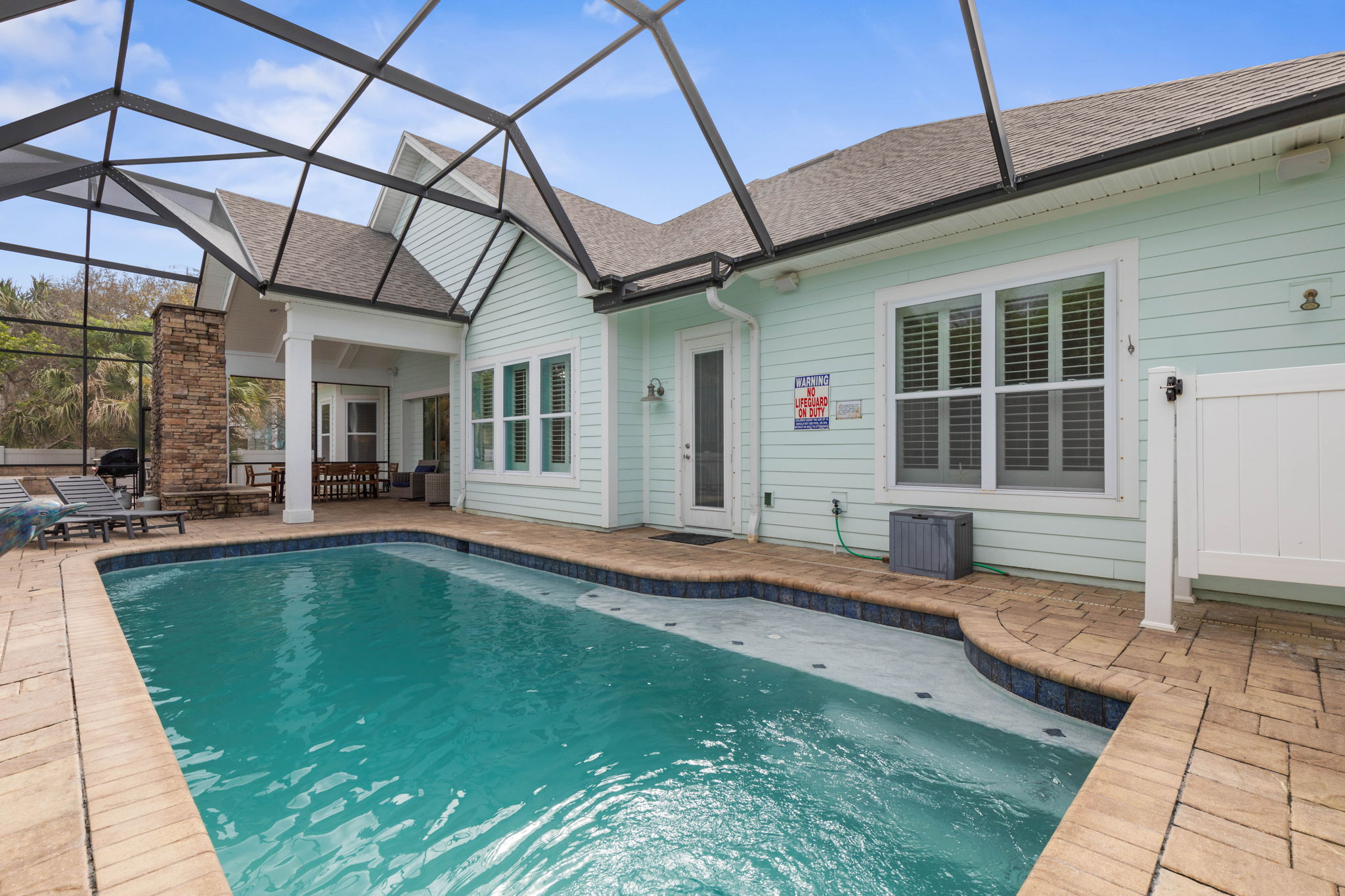 Spend the afternoon floating in your private pool, grill dinner under the lanai, and wind down by the outdoor fireplace as the sky turns gold—this screened retreat was made for easy beach days and even better nights together.