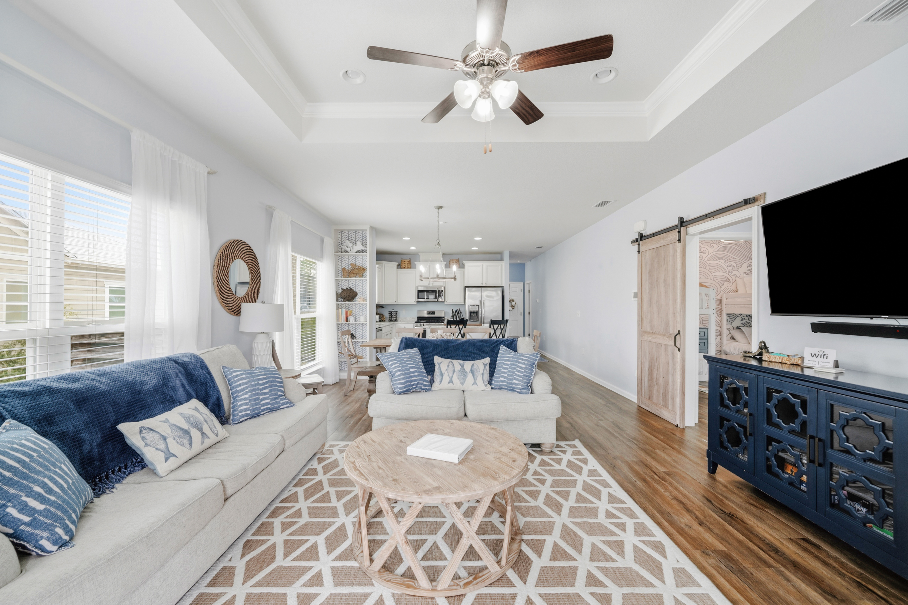 Unwind after a day at the beach in this bright, welcoming living room featuring plush seating, Smart TV, and plenty of space for family movie nights or relaxing together.
