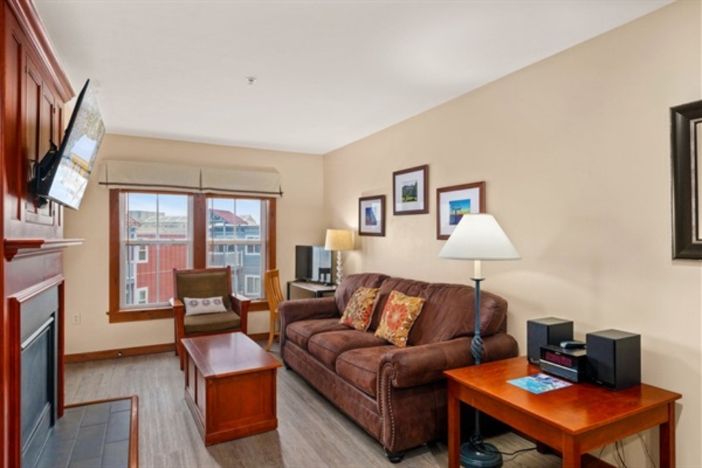 Catch up with Friends & Family in this Living Room with a Smart TV & Fireplace