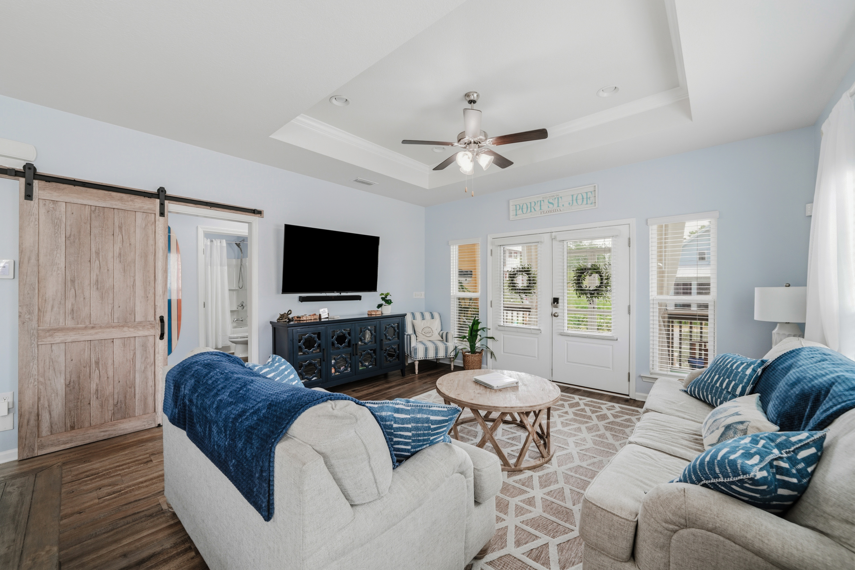 Relax in comfort. Bright and inviting living room with plush seating, perfect for movie nights or gathering with family and friends