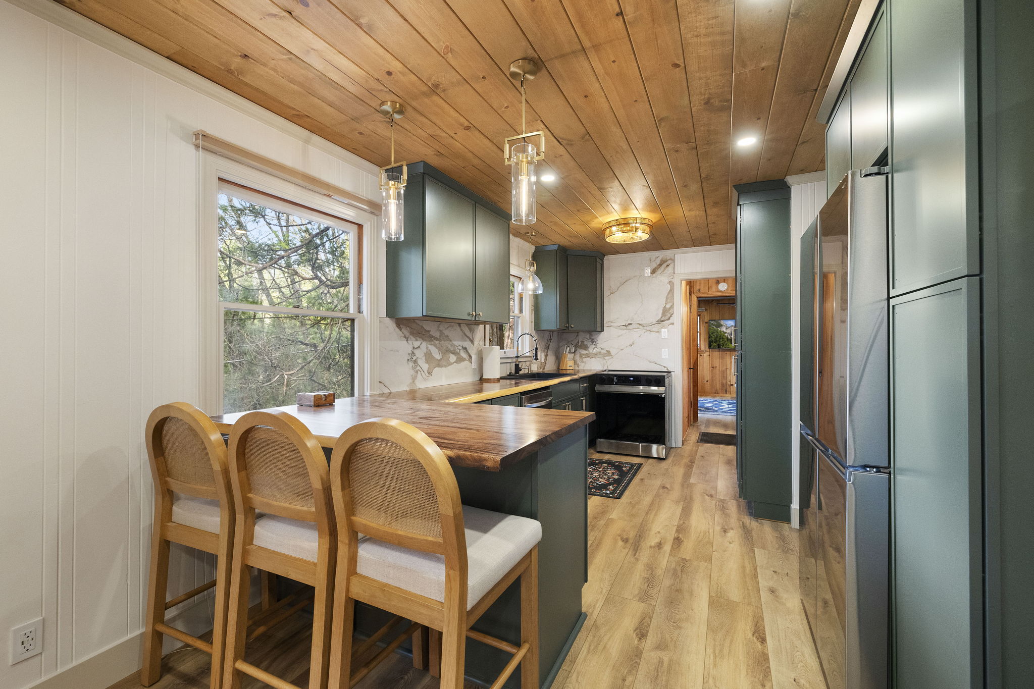 Brand new galley kitchen with peninsula area for seating or serving, full size dishwasher, microwave, stove, oven and oven hood. Plethora of storage. Plenty of glassware, dishes and silverware for your group. Spices and a few kitchen essentials as well.