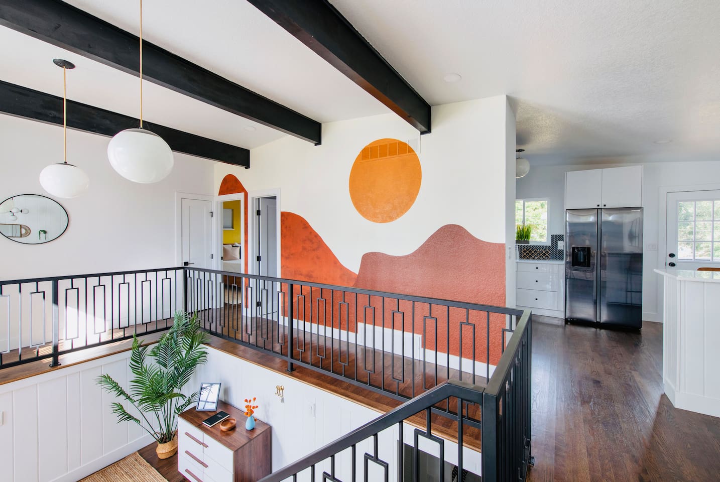 Retro inspired split level style entry with artistic mural and tons of natural light.