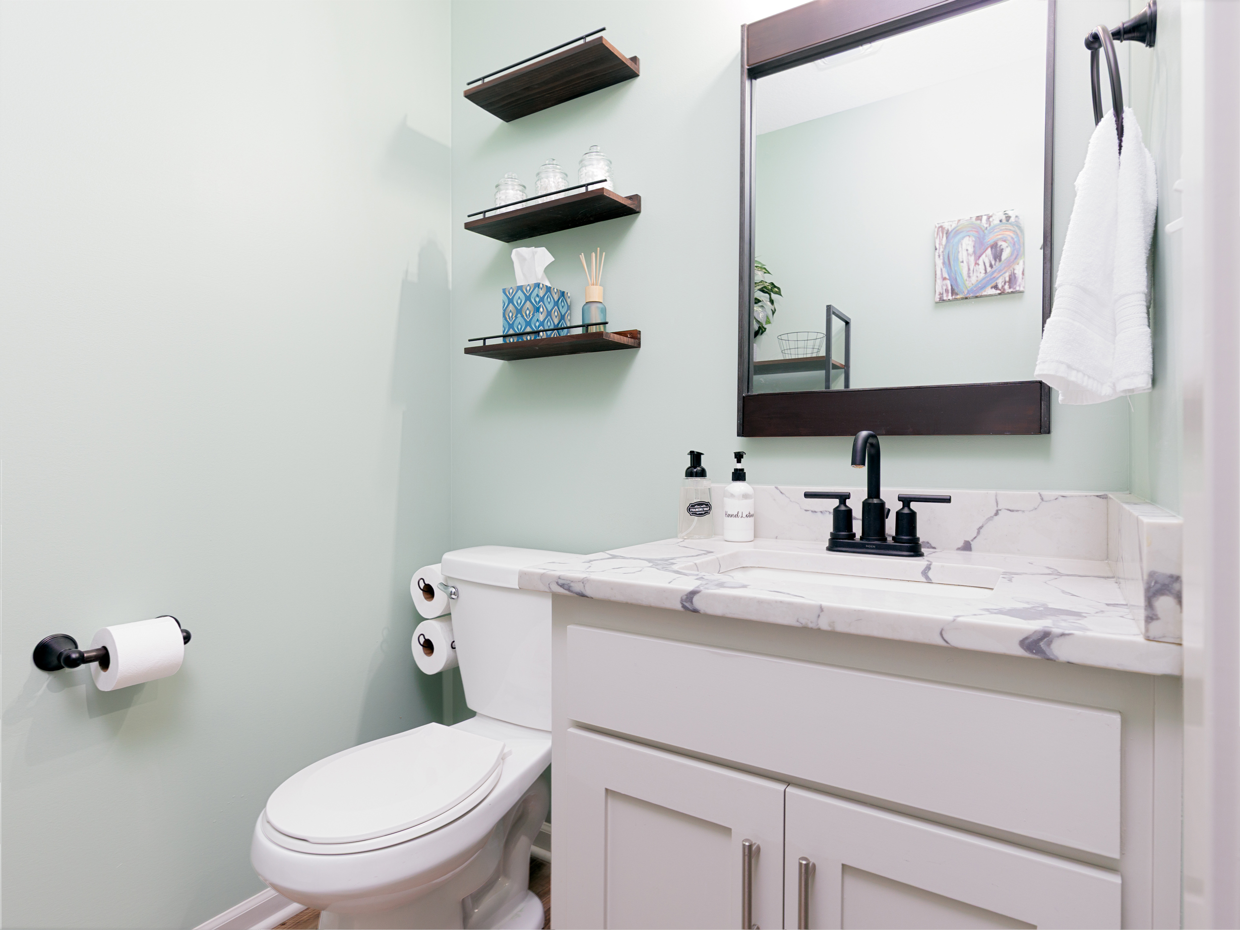 Convenient half bath located just off the main living area for added comfort and accessibility.