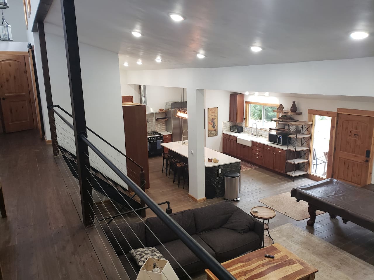 Open floor plan living room, kitchen, dining room. 2 Farmhouse style sinks. Live edge shelves. fully stocked kitchen. 