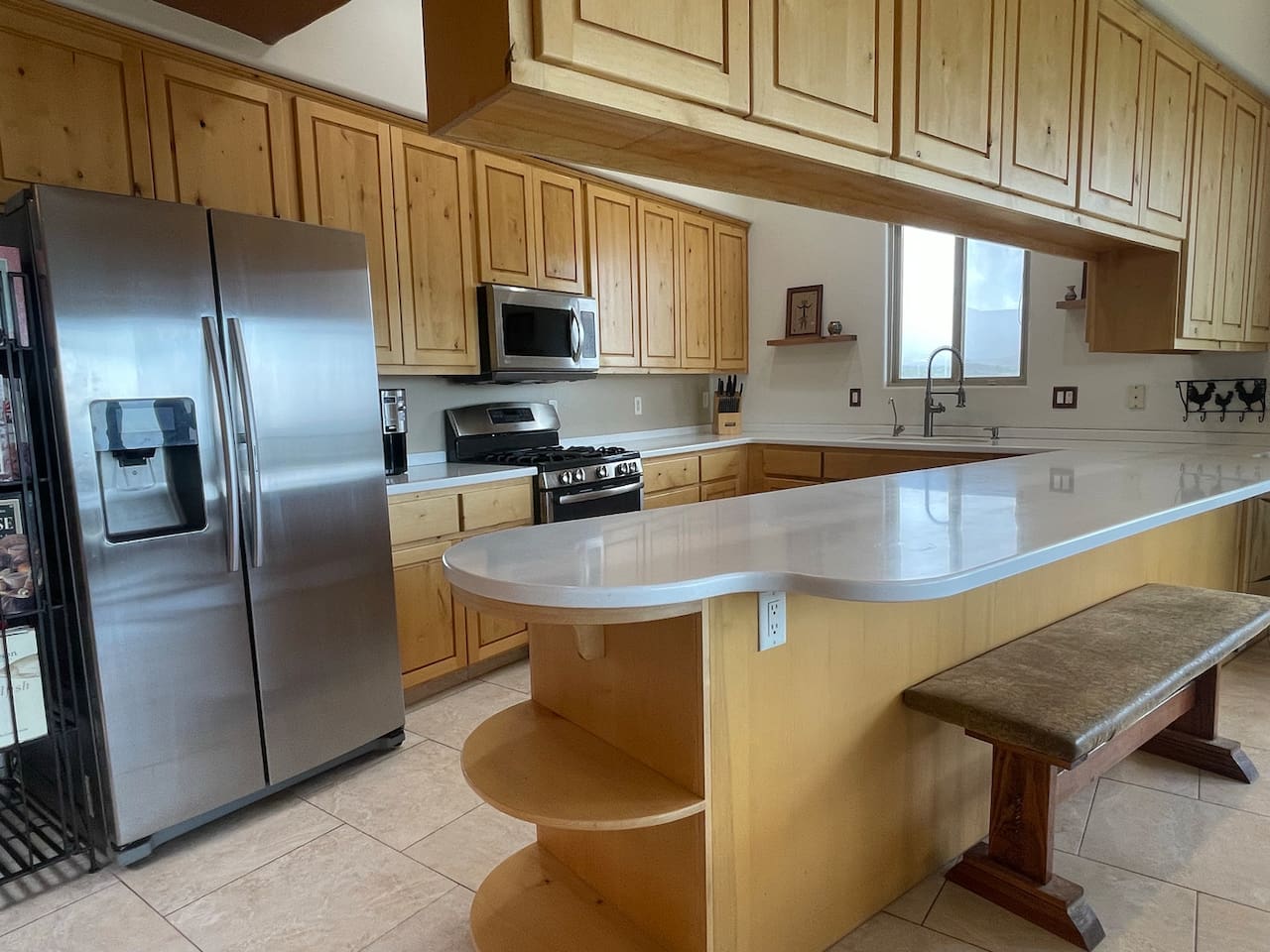 The large peninsula adds extra workspace and casual seating to this inviting kitchen.
