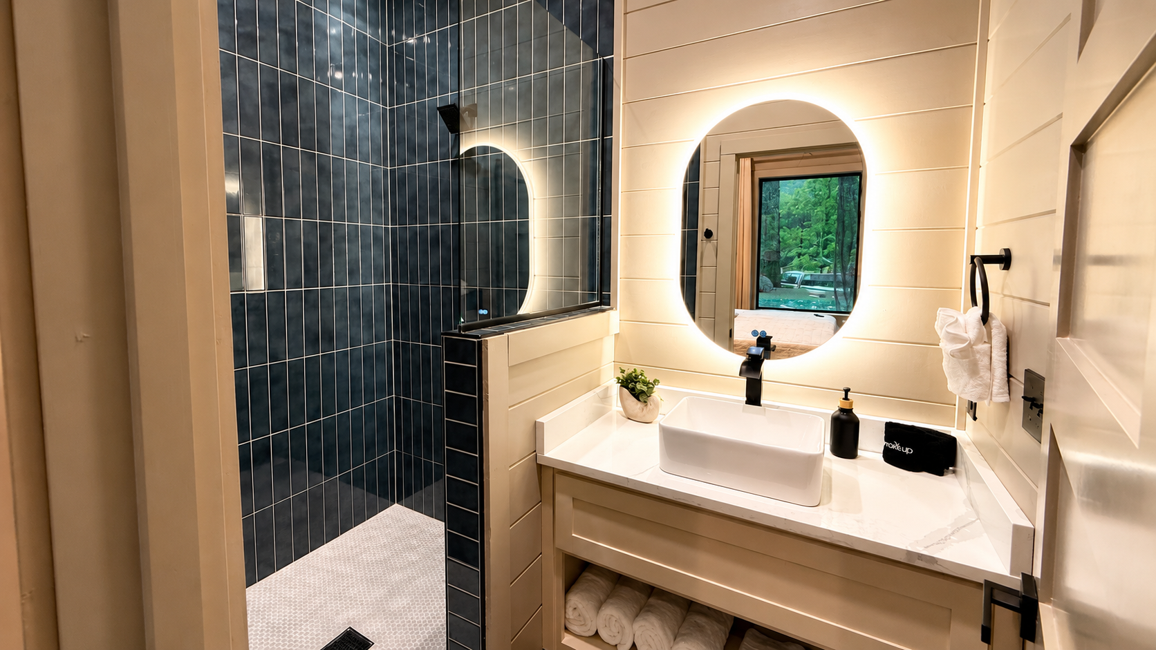 Luxurious Bathroom: Refresh in a stunning tiled retreat with nature views and elegant lighting!