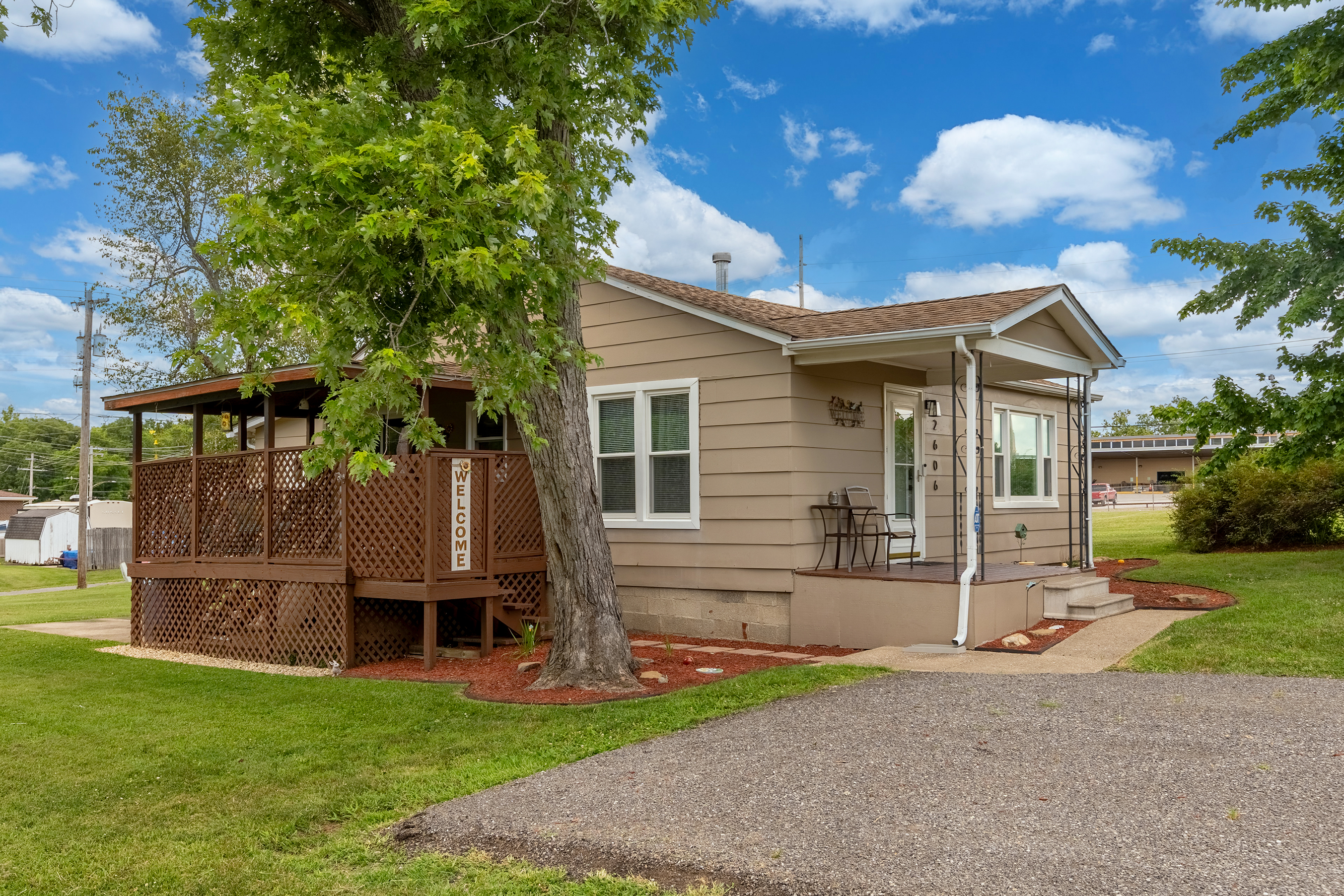 Step inside in style. A covered front porch welcomes you home, framed by lovely landscaping.