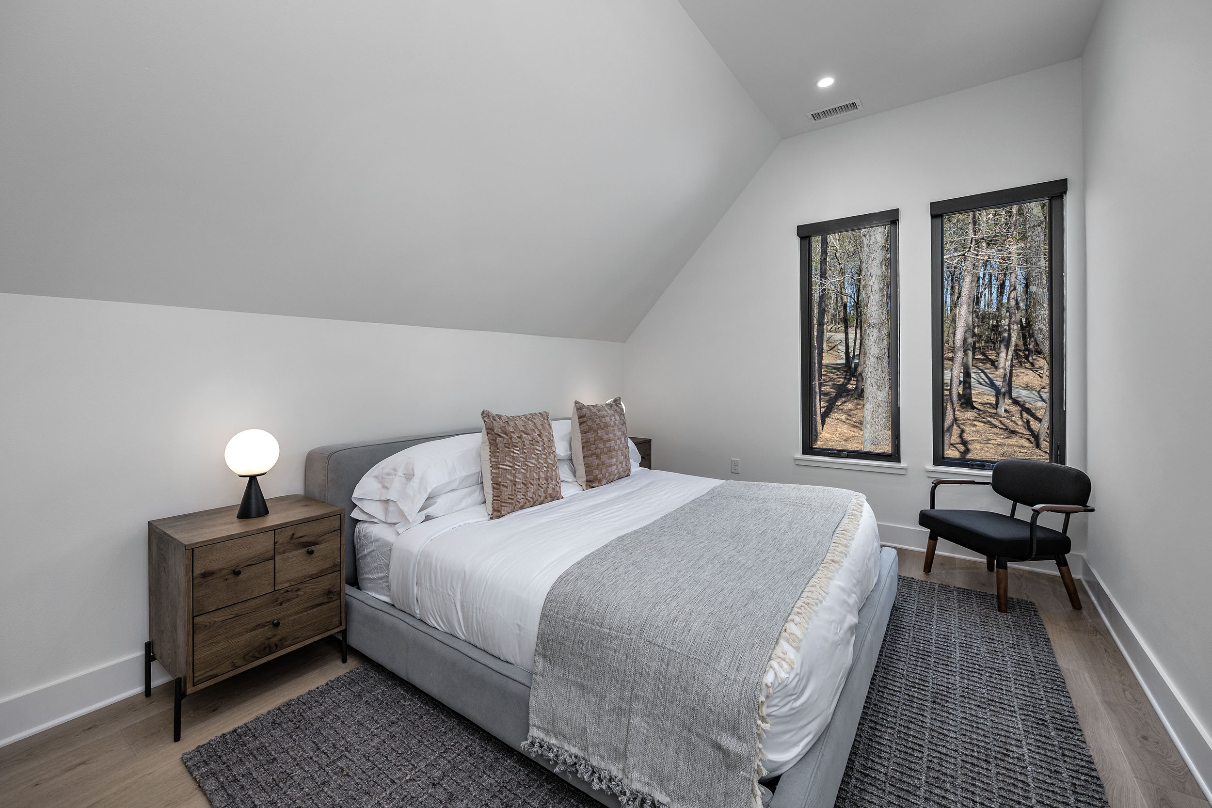  A cozy king suite tucked upstairs with peaceful forest views and simple, sophisticated comfort.