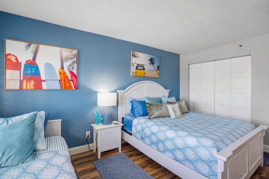 Bright bedroom 2 in this beachfront vacation rental featuring comfortable bedding and beach-inspired décor for a relaxing stay.