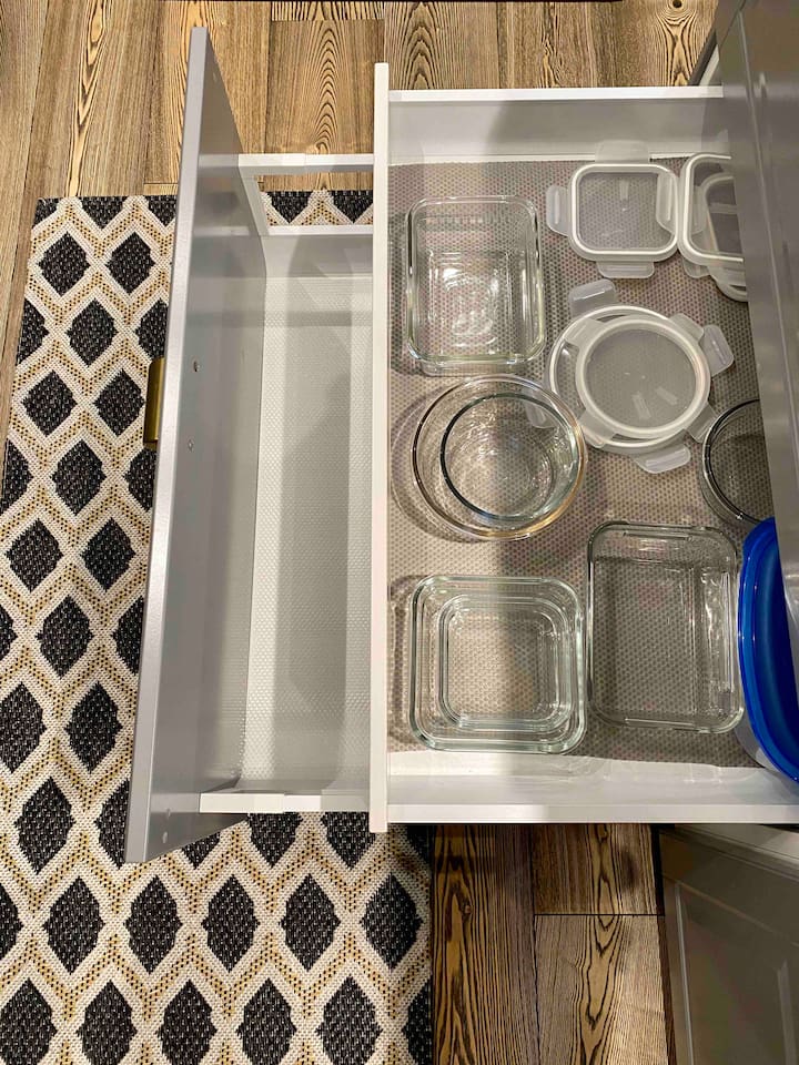 Kitchen Island.
Second drawer on the left has.
1. Top one has containers
2. Is empty