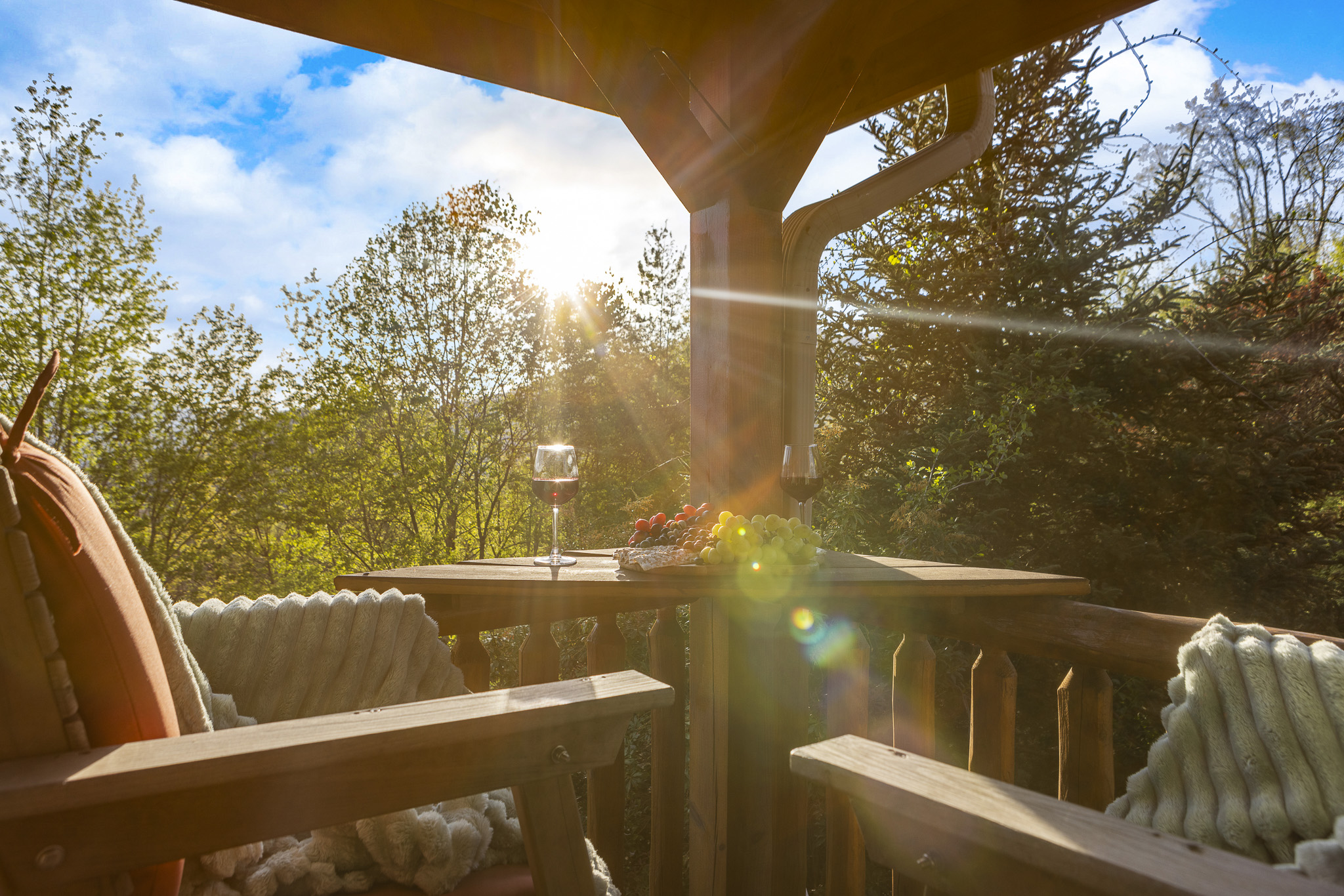 Balcony Retreat: Sip wine under the sun, surrounded by lush views and delightful treats!