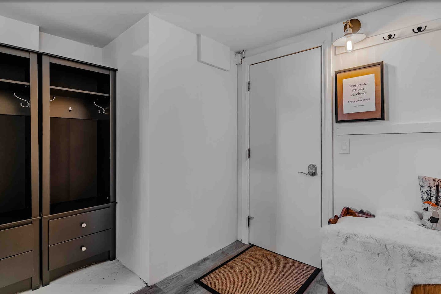 Basement entry with open storage for coats, shoes, and outdoor gear