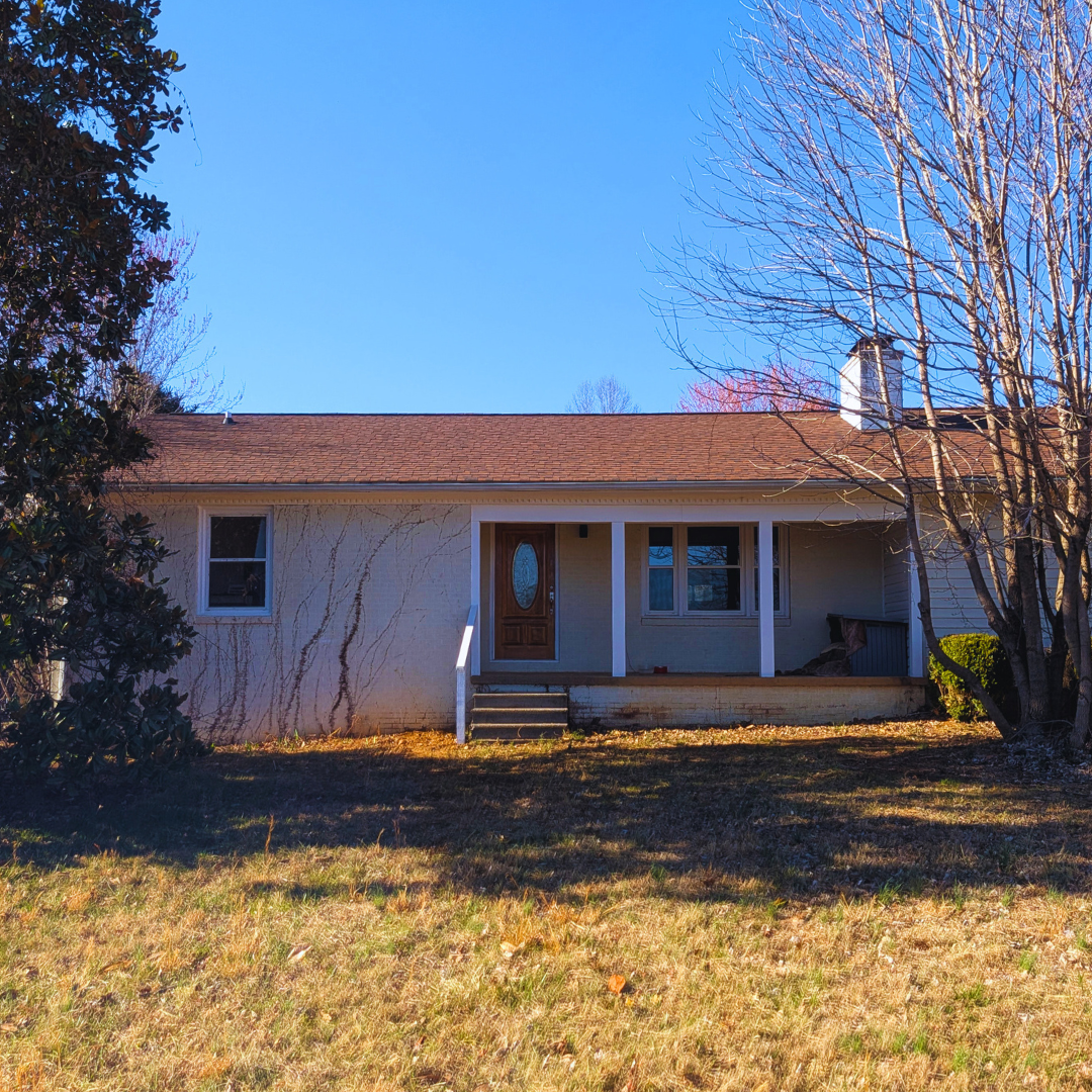 Welcoming home with a spacious front lawn and charming covered porch, a peaceful place to relax and unwind