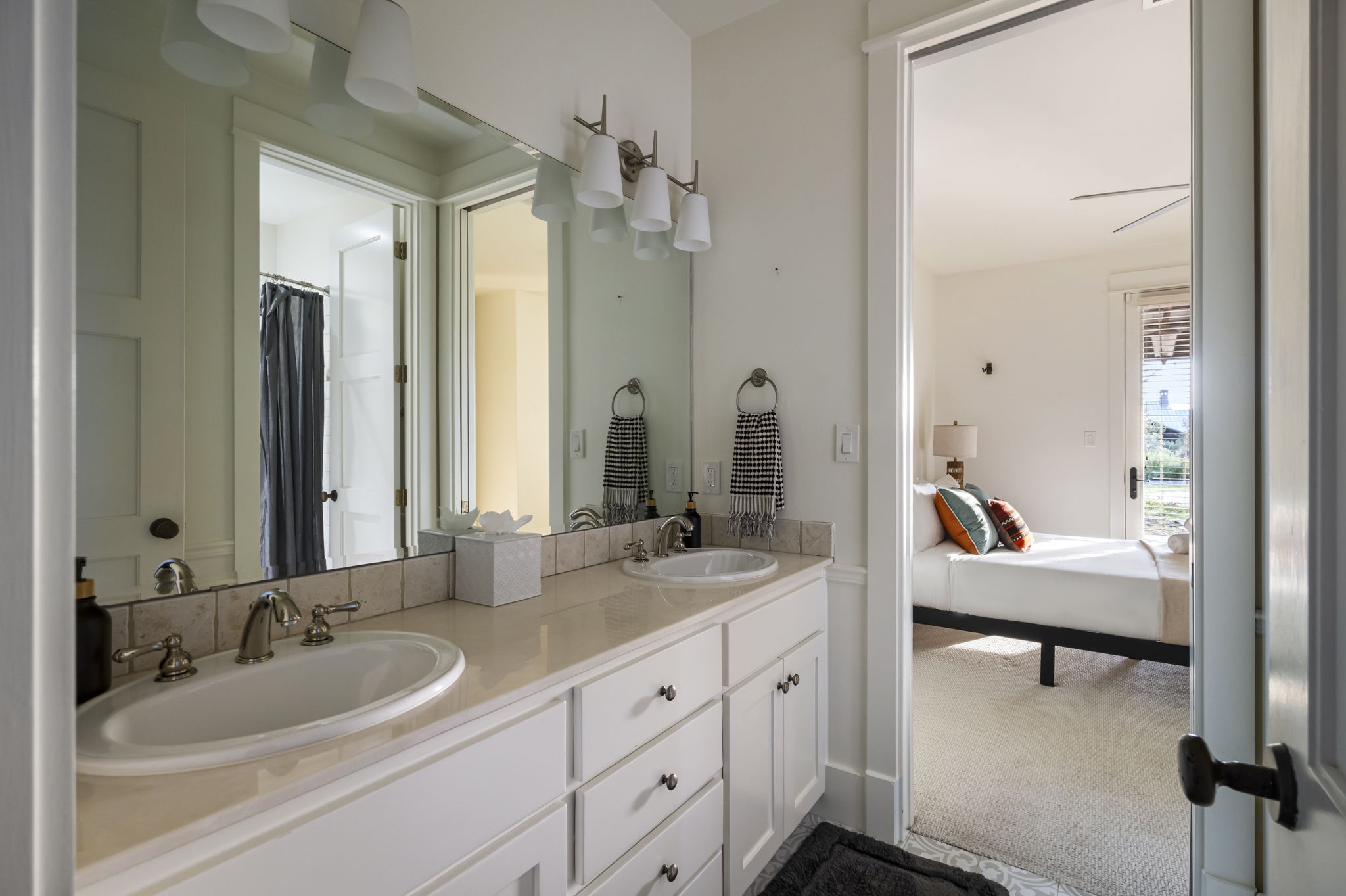 Start your day refreshed in our bright, dual-sink bathroom, conveniently located next to a cozy bedroom for ultimate comfort and privacy