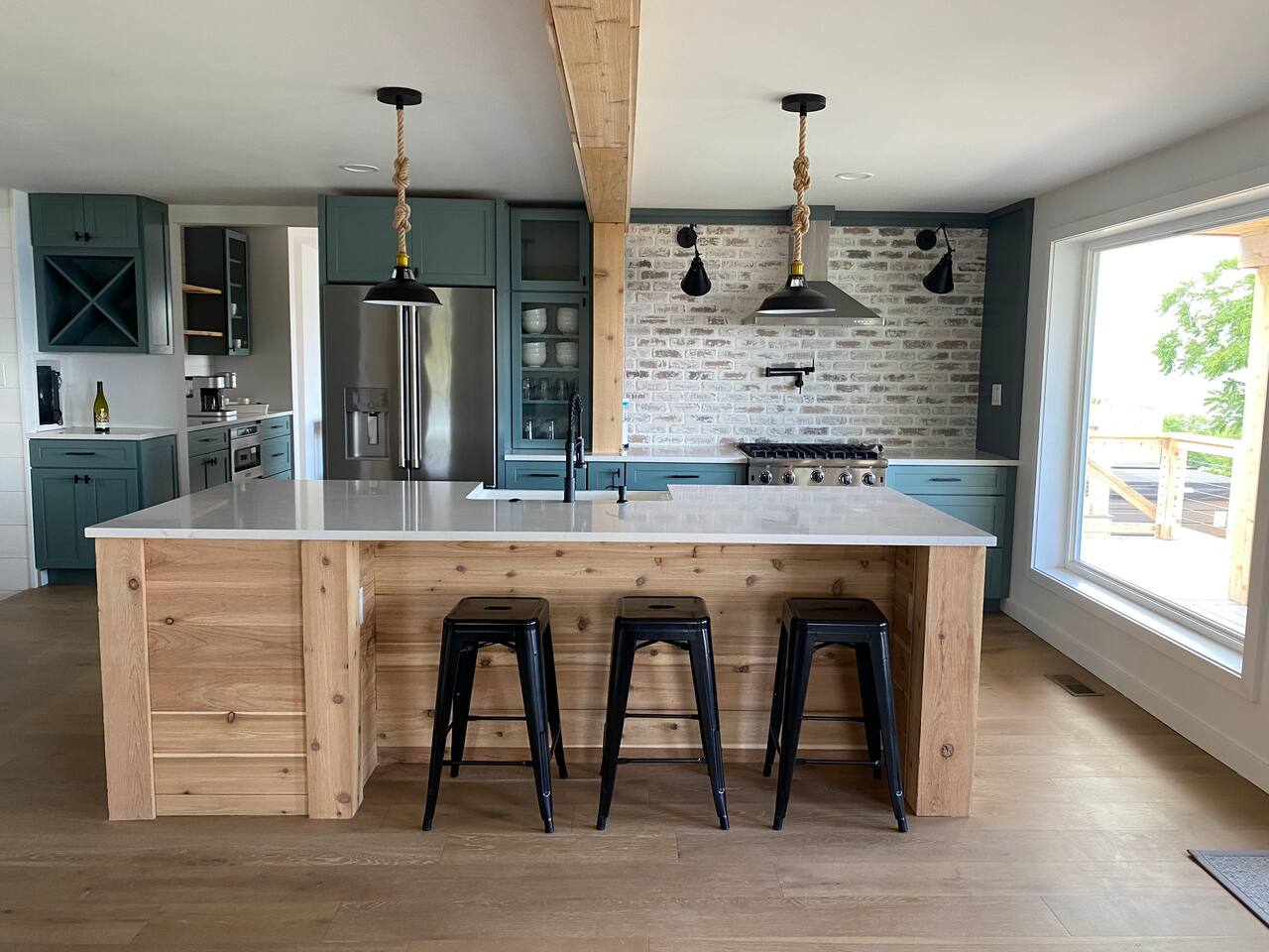 Open concept kitchen, includes standard appliance package + beverage fridge +oven with pot filler