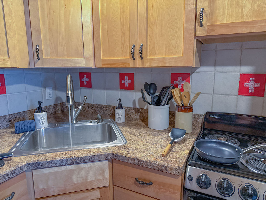 Featuring: Oven, electric stove, utensils, hand soap, dish soap...