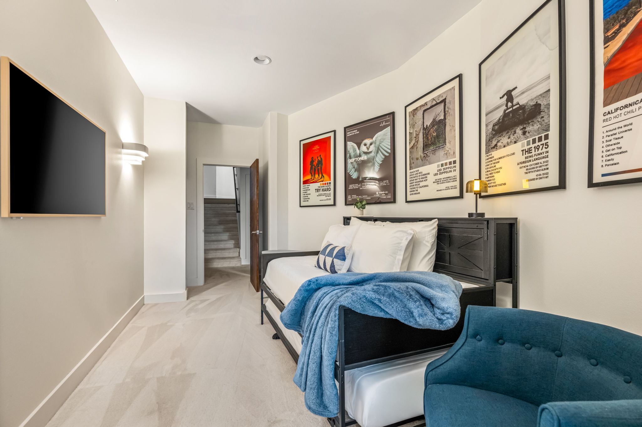 Private bedroom with smart TV and a cozy lounge chair