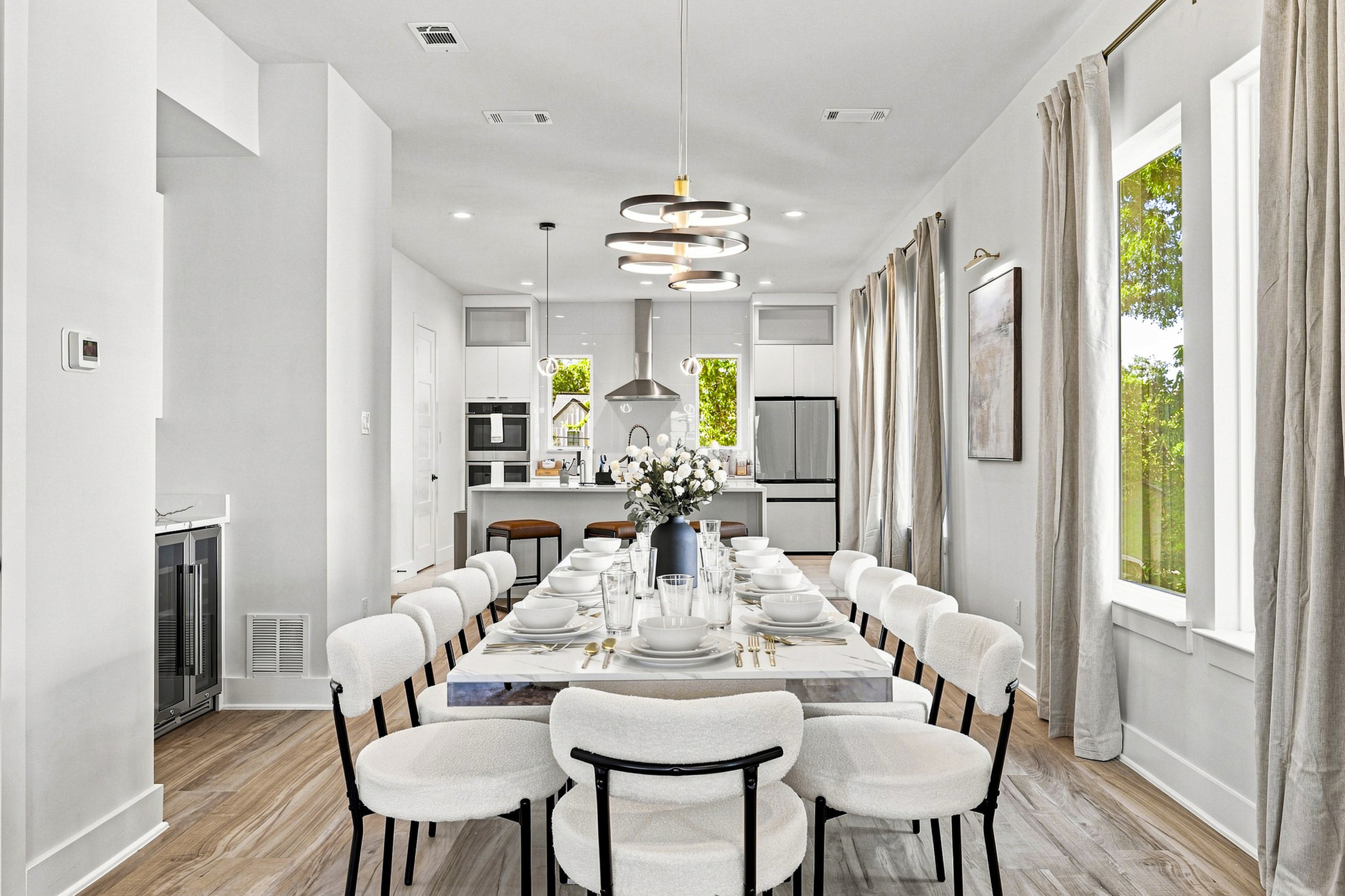 Gather around the sleek table, perfect for feasts and fun in bright, airy elegance!