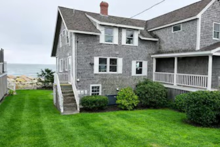 Charming seaside home featuring classic coastal architecture, a spacious lawn, and direct proximity to the shoreline—perfect for enjoying peaceful oceanfront living. 🌊🏡
