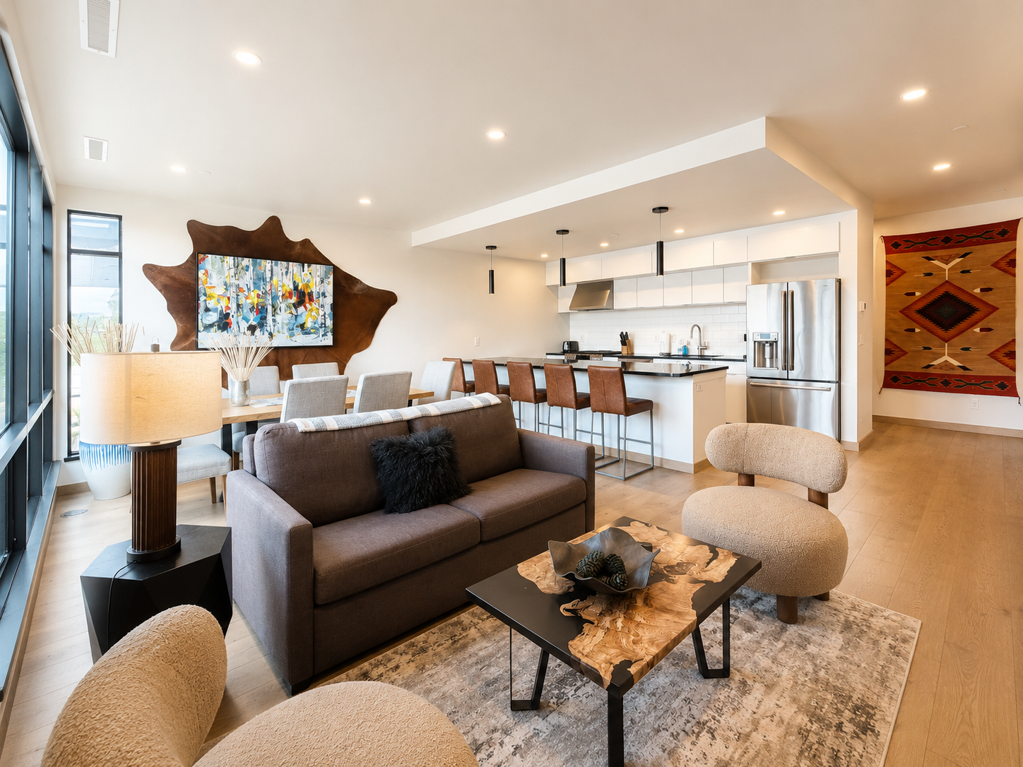 Main living space with open modern living room and kitchen. The living room features a luxury full sofa sleeper.