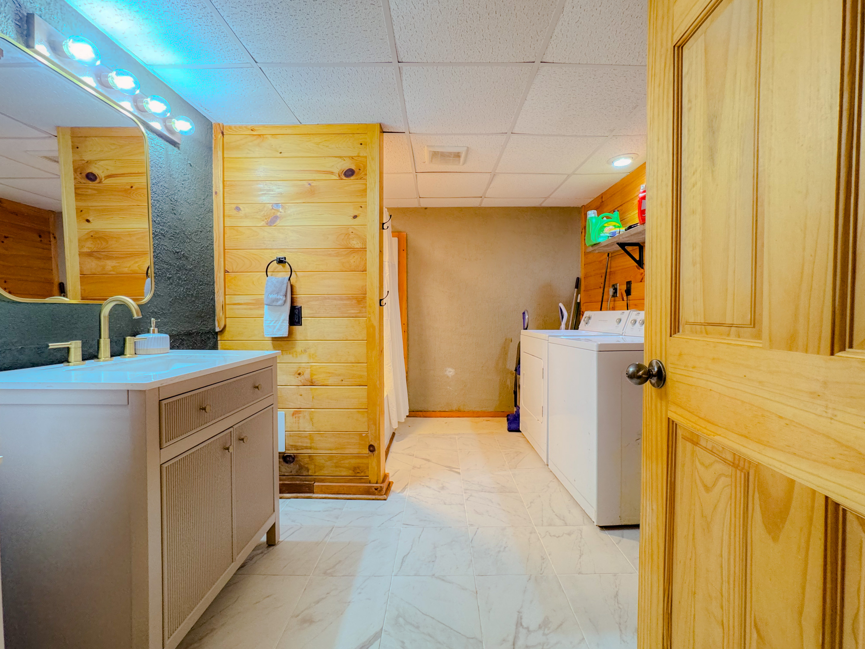 lower level bathroom features a washer and drew for guest use