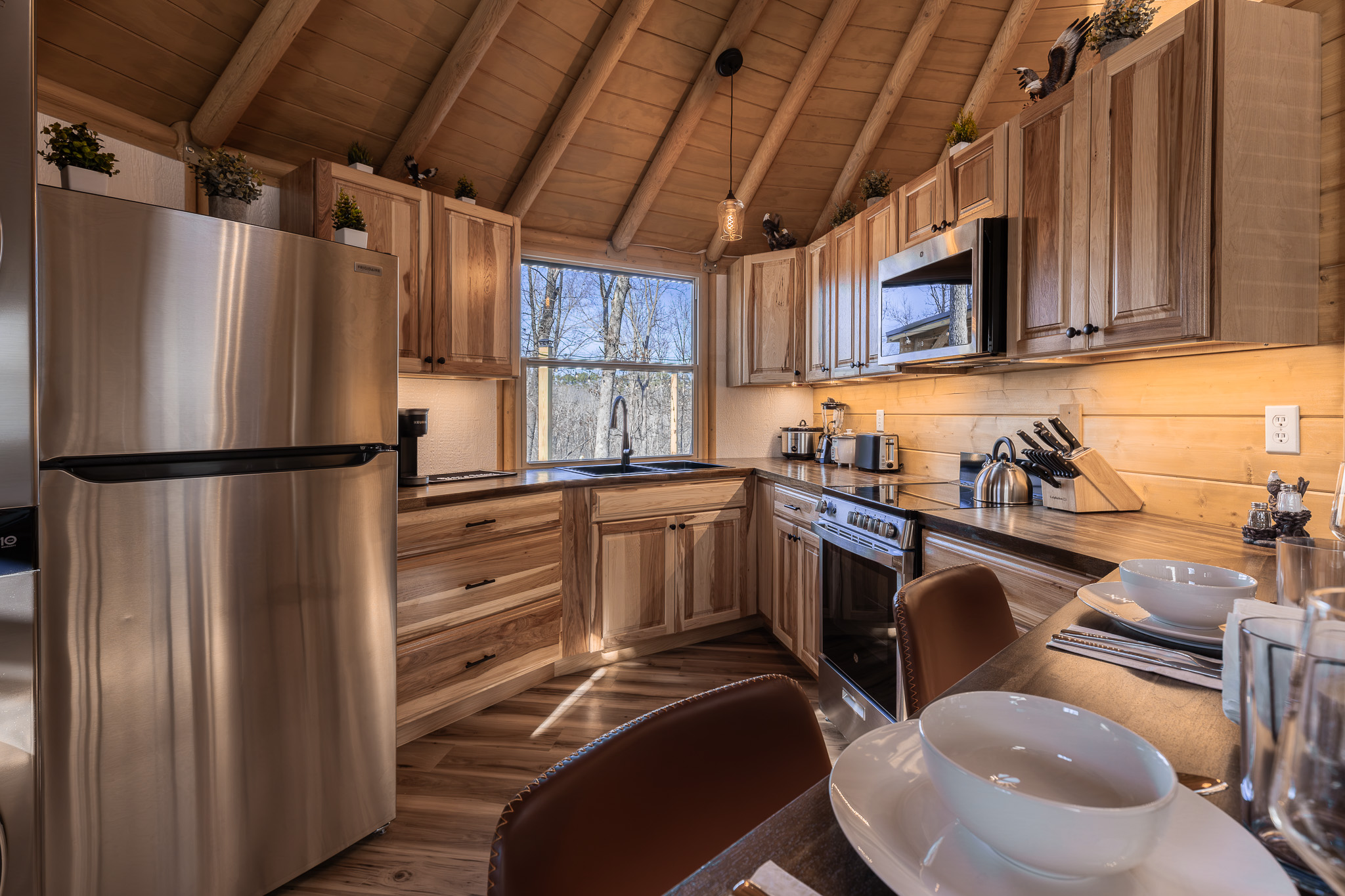 Fully equipped kitchen with full-size stainless appliances, custom wood cabinetry, and everything needed for relaxed meals or romantic dinners in the dome.