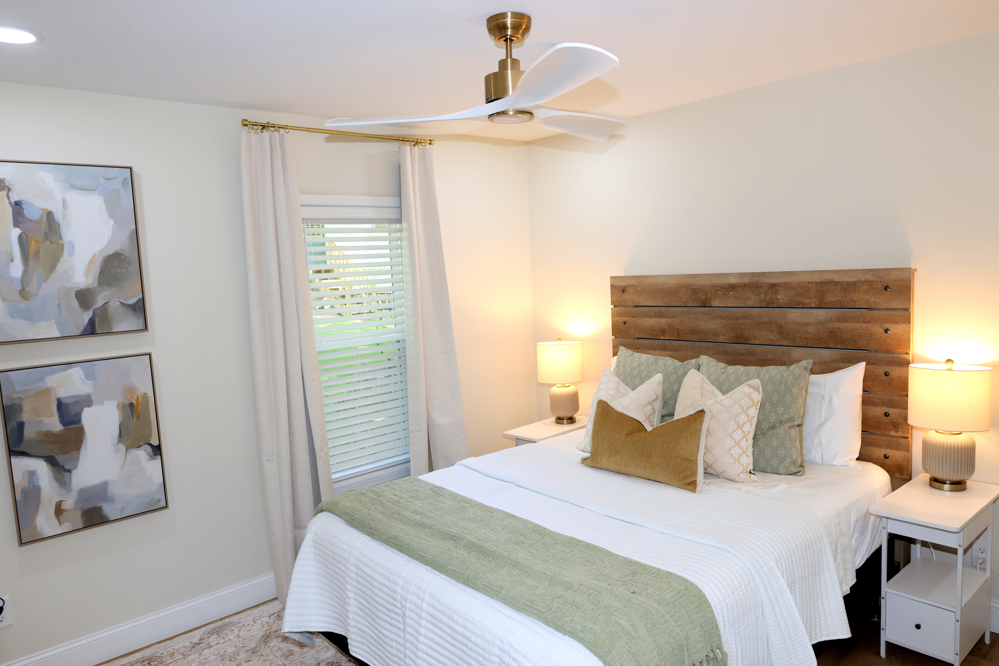 Cozy bedroom with warm wood headboard, soft bedding, and relaxing lake-house décor