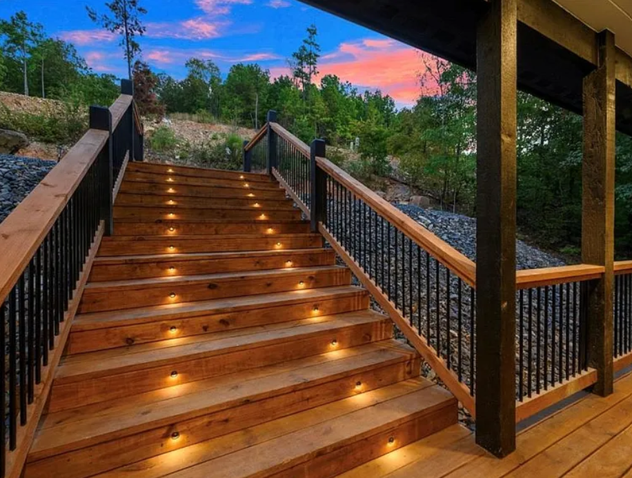 Beautifully lit staircase leading to the property with a warm welcome.